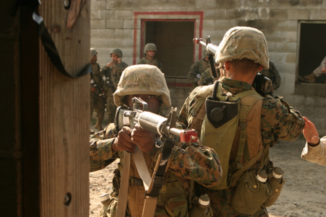 Marines from Hotel Company, Marine Combat Training Battalion(MCT), School of Infantry-East, patrol by a window during Military Operations on Urban Terrain training exercise at Camp Devil Dog Mout Town, Camp Geiger, North Carolina, on August 18, 2008 (U.S. Marine Corps photo by Pfc. Maxton G. Musselman)