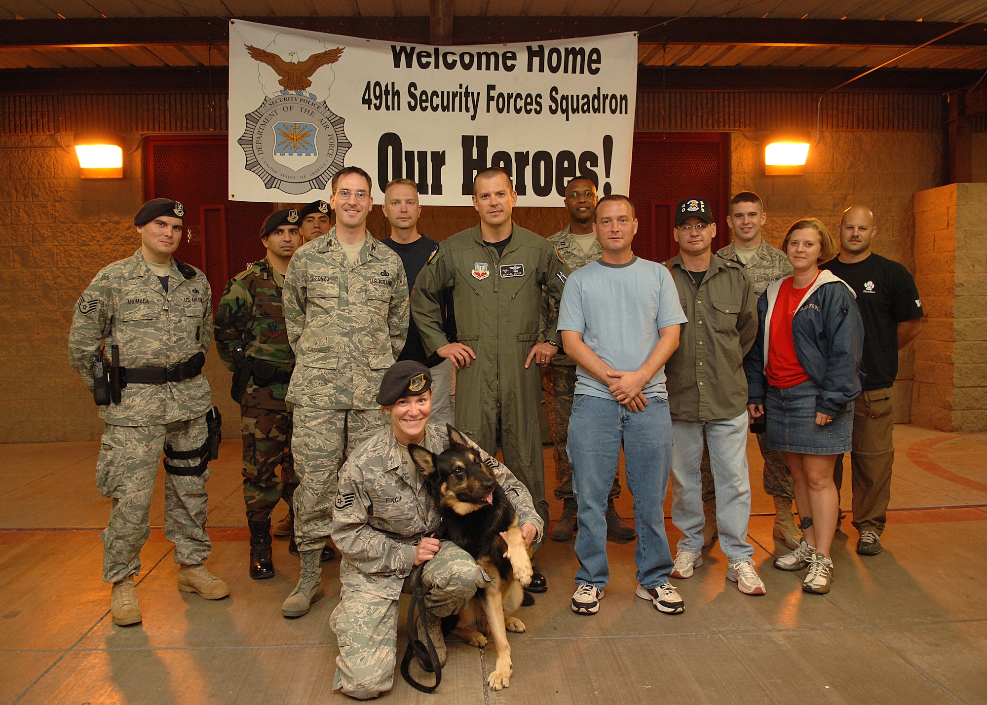 Staff Sgt. Stephanie Finch, 49th Security Forces Squadron, poses with Col. Michael McGee, 49th Fighter Wing vice commander, and members of the 49th SFS Aug. 16 at Holloman Air Force Base, N.M. (U.S. Air Force Photo by A1C John D. Strong II)