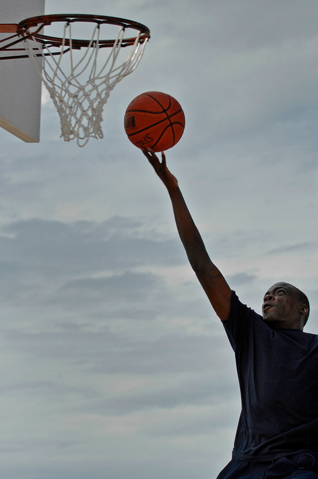 Airman 1st Class Adam Grant, 28th Bomb Wing still photographic apprentice, performs a lay-up during a 3 on 3 basketball competition as part of the Ellsworth Olympic Picnic, Aug. 15. Multiple base organizations sponsored the picnic by providing volunteers, equipment, and food. (U.S. Air Force photo/Senior Airman Marc I. Lane)