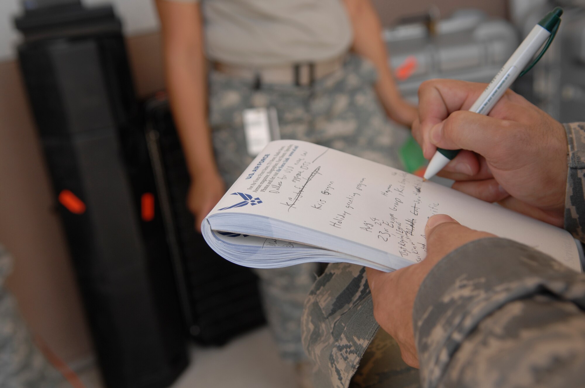 A member of the Hometown Holiday Greets teams takes notes before the 45-day trip across the world.  Three teams from the Air Force News Agency in San Antonio are dedicated to filming servicemembers across the globe in an effort to bring them closer to their families back home. (U.S. Air Force photo/Master Sgt. Cecilio Ricardo)