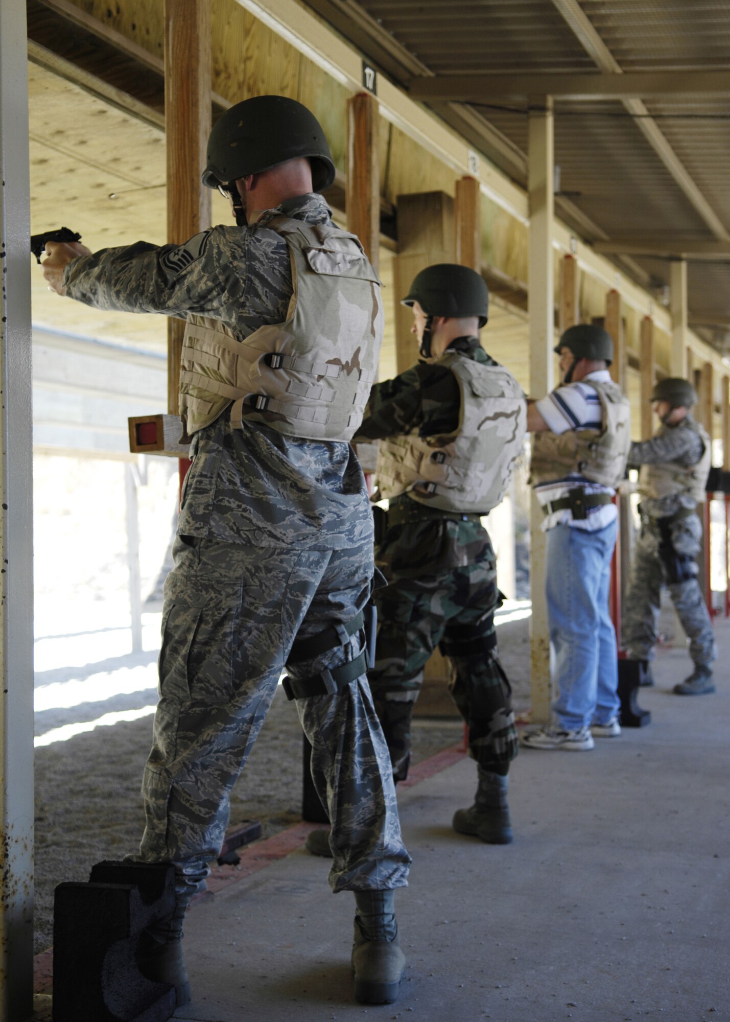 VANDENBERG AIR FORCE BASE, Calif. --  A four-person M-9 qualification team fire their weapons during their evaluation of proper technique and skill.  The team needs to qualify before leaving for their deployment. (U.S. Air Force photo / Airman 1st Class Heather Shaw)