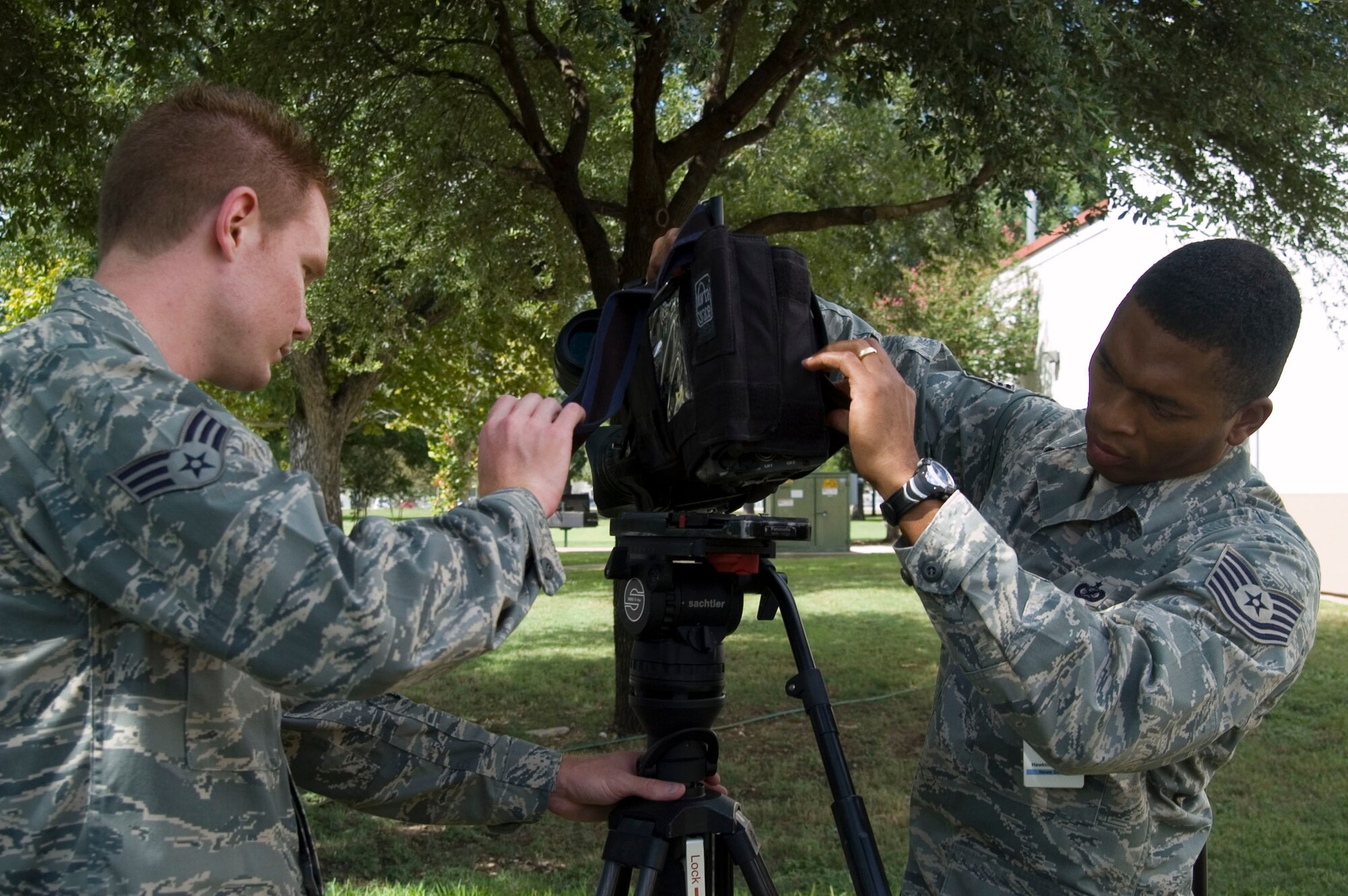 Senior Airmen Grant Hagman and Tech. Sgt. Dwight Hawkins prepare video gear Aug. 18 for the Hometown News Holiday Greets trip. The team of nine will leave Air Force News Agency in San Antonio in late August to begin their mission that allows nearly 15,000 families to see their deployed loved ones. The teams  will visit more than 75 military installations in 20 countries. (U.S. Air Force photo/Tech. Sgt. Matthew McGovern)  
