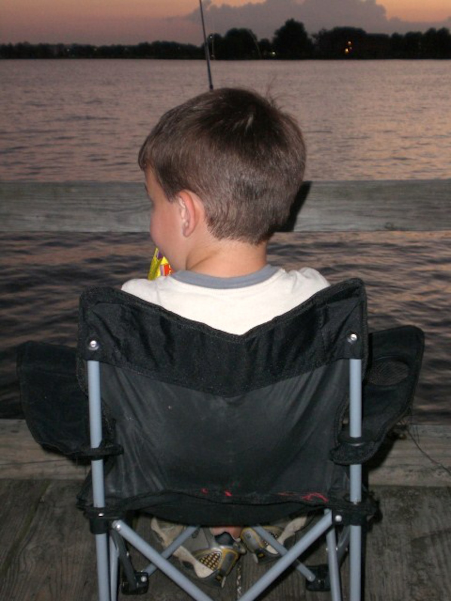 Tyler Wyatt, 5, enjoys a night of fishing Aug. 17 on the King Street Pier. Due to excessive damage and unavailable funding for repairs, the pier will permanently close to the public Sept. 2. (U.S. Air Force photo/Staff Sgt. Heidi Davis)