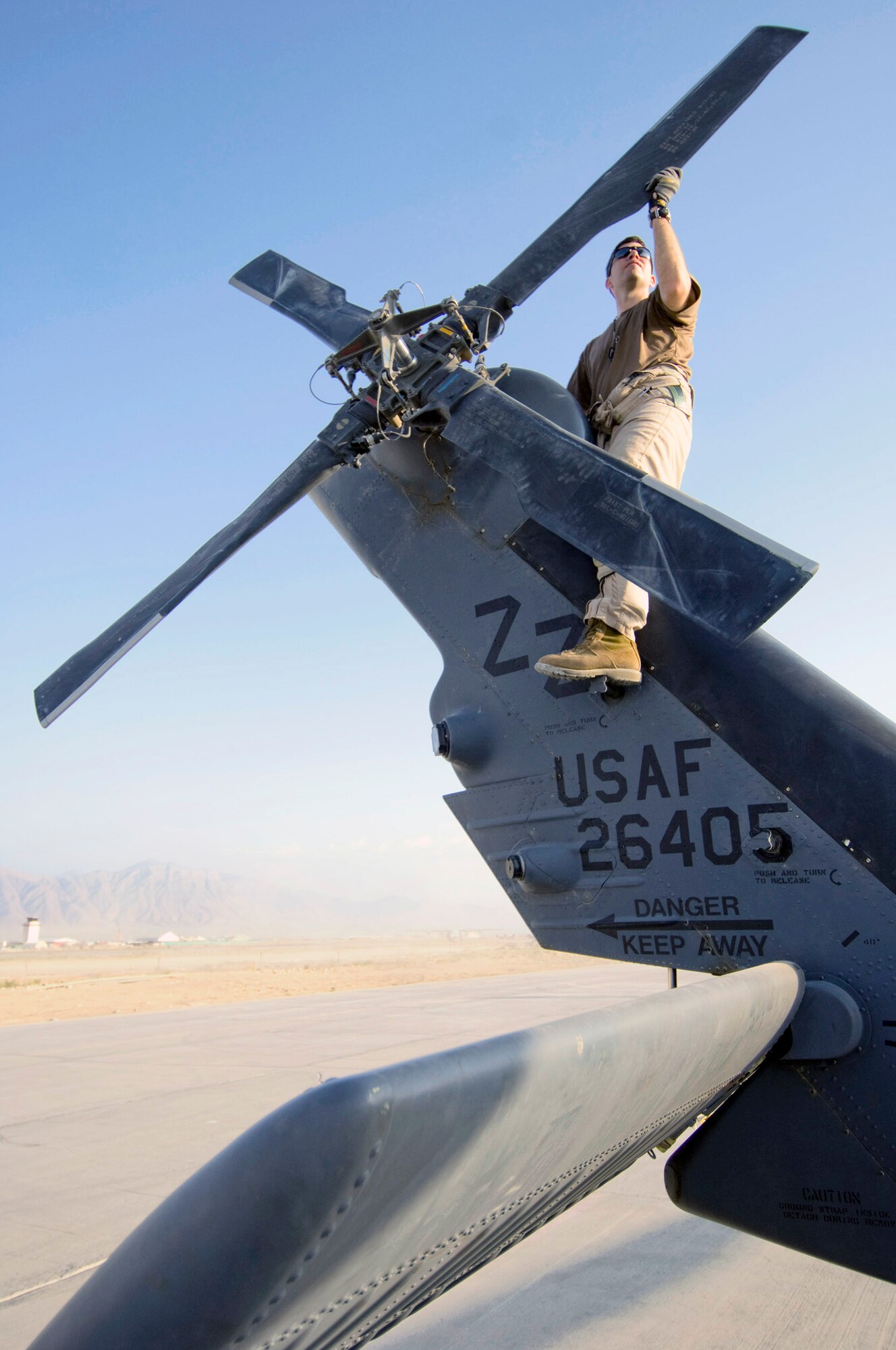 Staff Sgt. Gerald Messier, a 33rd Expeditionary Rescue Squadron flight engineer, checks the rear rotor on an HH-60G Pave Hawk before takeoff Aug. 2 at Bagram Air Base, Afghanistan. Before every mission, the flight crew must check to ensure that all the systems are operational. Sergeant Messier is deployed from the 33rd Rescue Squadron at Kadena AB, Japan. (U.S. Air Force photo/Staff Sgt. Samuel Morse)