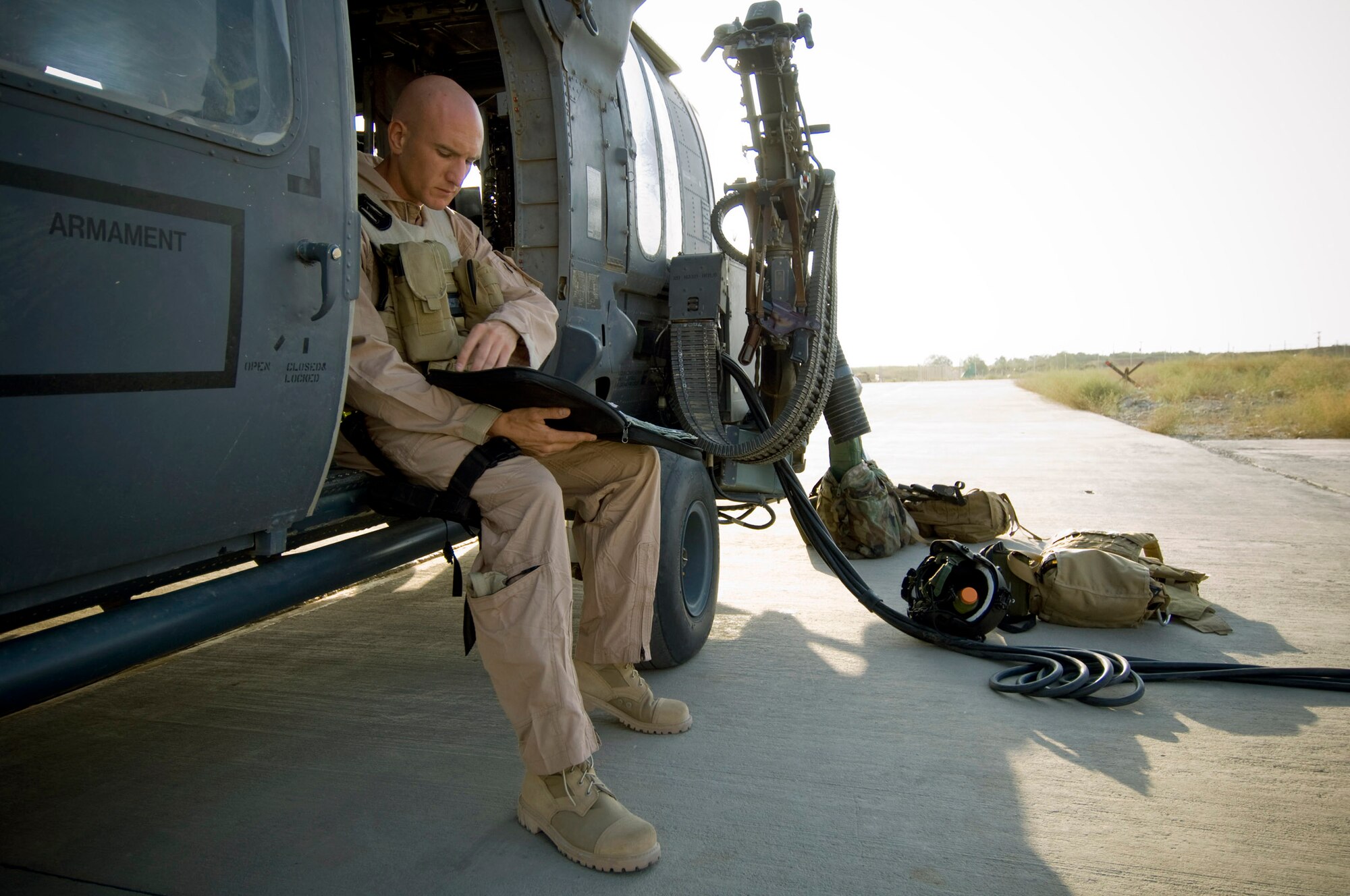 Capt. Tavis McDevitt, a 33rd Expeditionary Rescue Squadron pilot, reads through preflight paperwork Aug. 2 at Bagram Air Base, Afghanistan.  Captain McDevitt is deployed from the 33rd Rescue Squadron at Kadena AB, Japan. (U.S. Air Force photo/Staff Sgt. Samuel Morse)