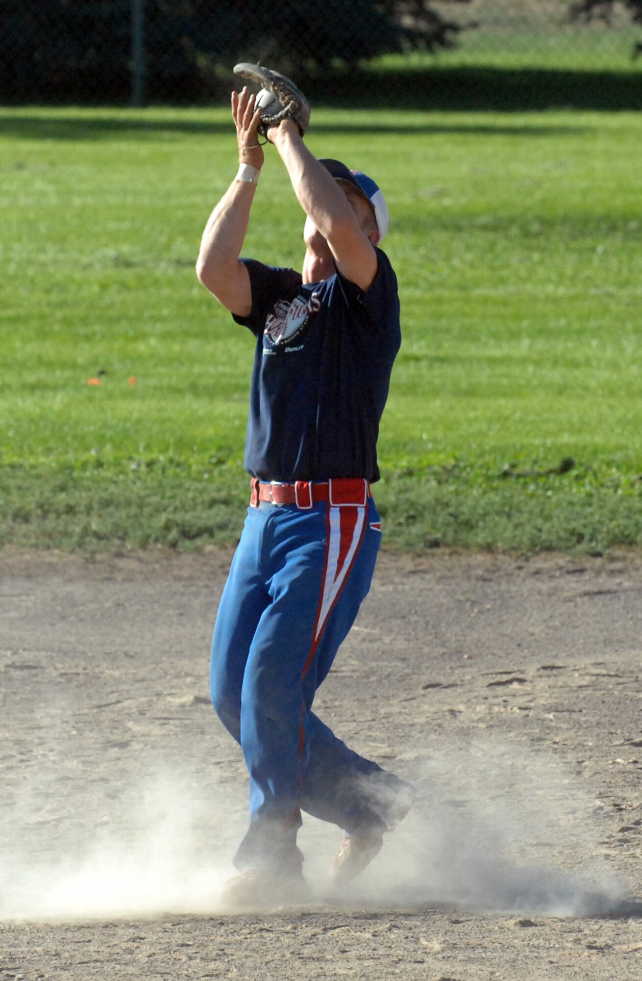 Jeremy Cummins, 366th Logistics Readiness Squadron shortstop, catches a fly ball to the infield during the intramural championship game Aug. 13. The 726th Air Control Squadron defeated the 366th LRS B Team 12 – 1 to win the championship. (Photo / Airman 1st Class Ashley Winters)