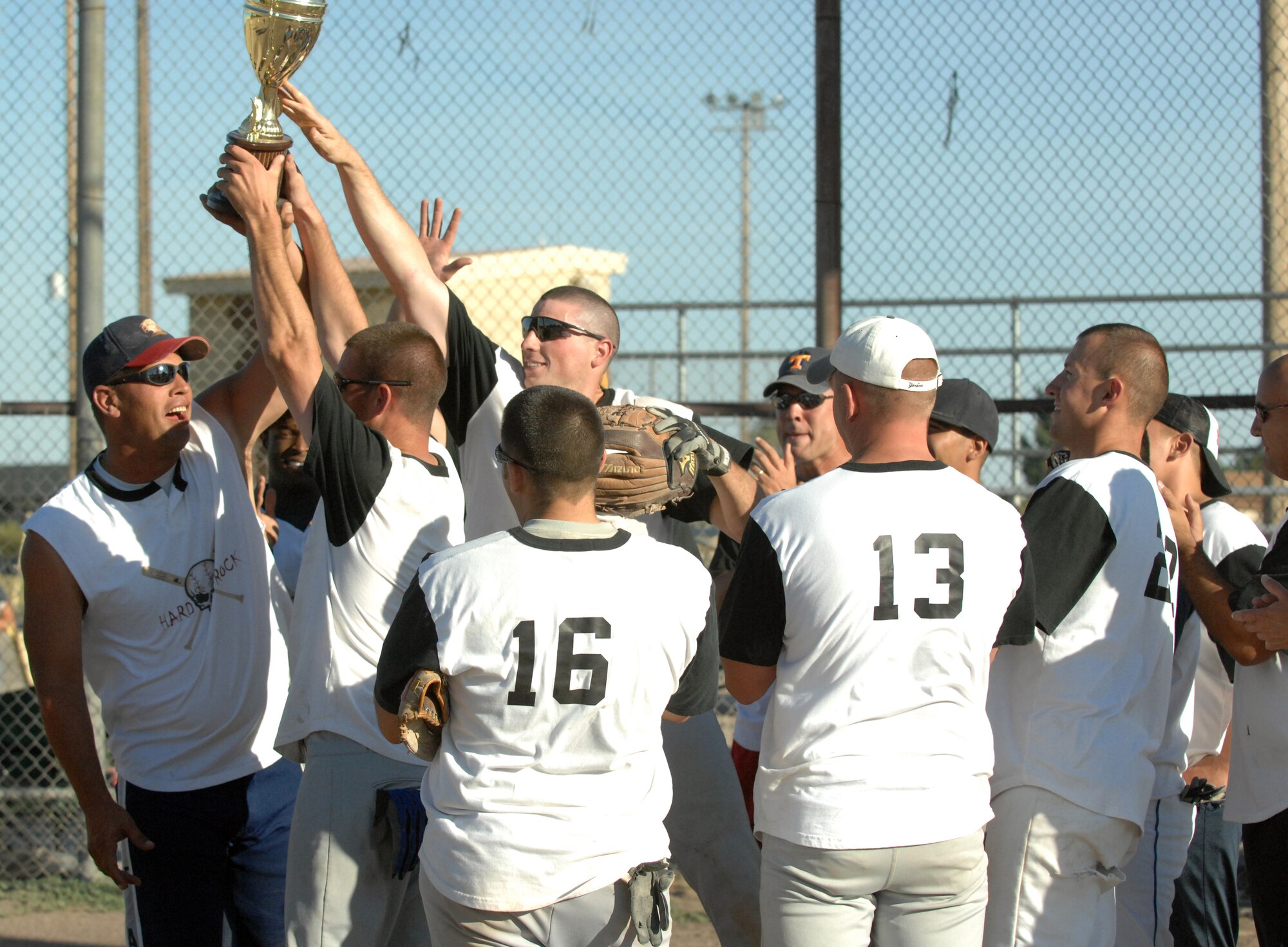 The 726th Air Control Squadron celebrates after getting the championship trophy after defeating the 366th Logistics Readiness Squadron 12 – 1 Aug. 13. (Photo / Airman 1st Class Ashley Winters)