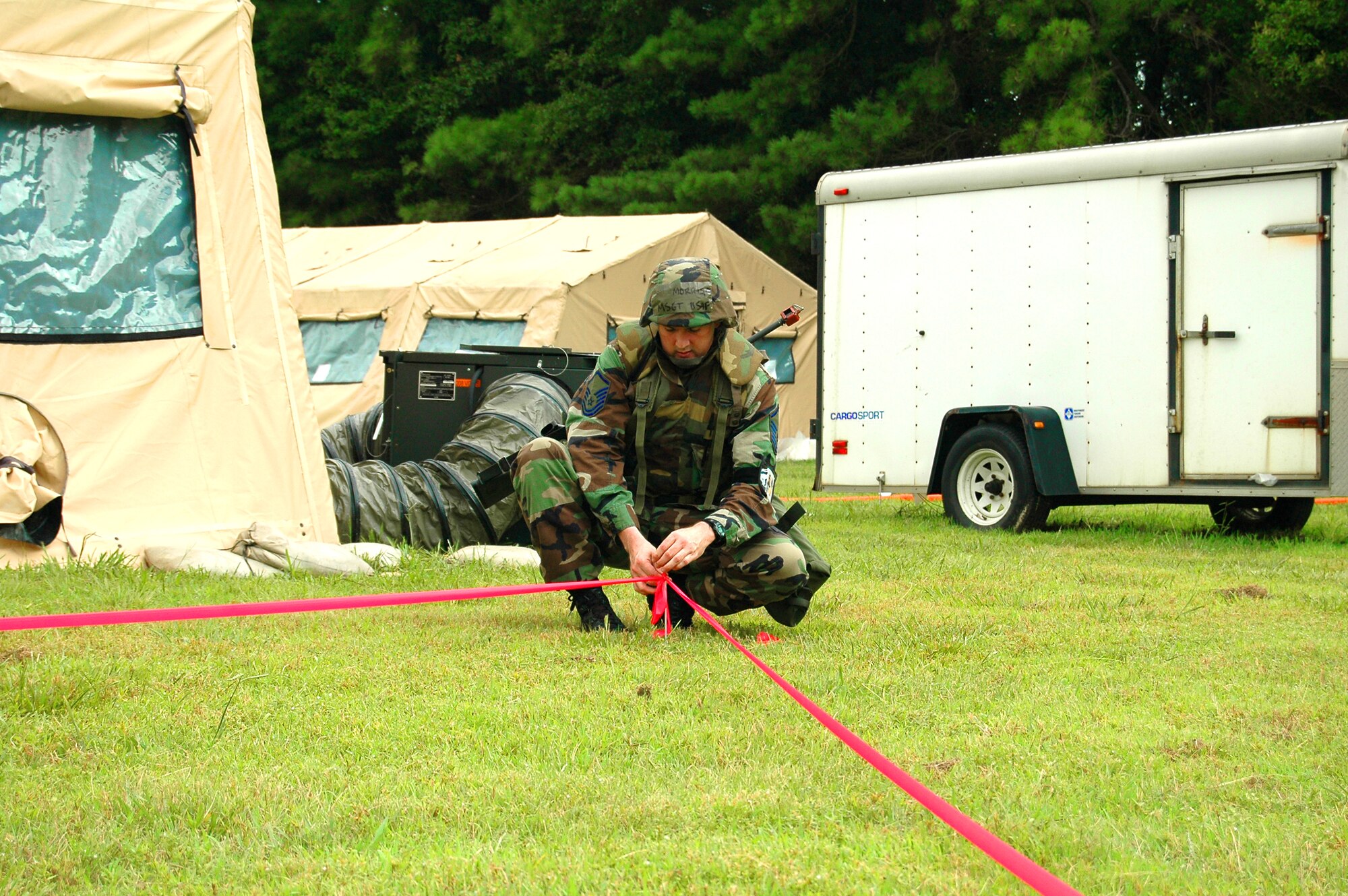 Master Sgt. Mike P. Morris, a member of the 94th Airlift Wing's Operational Support Squadron, sets up a perimeter around a replicated Uexploded Ordnance as part of a sweep conducted after an exercise as part of the Operational Readiness Exercise.