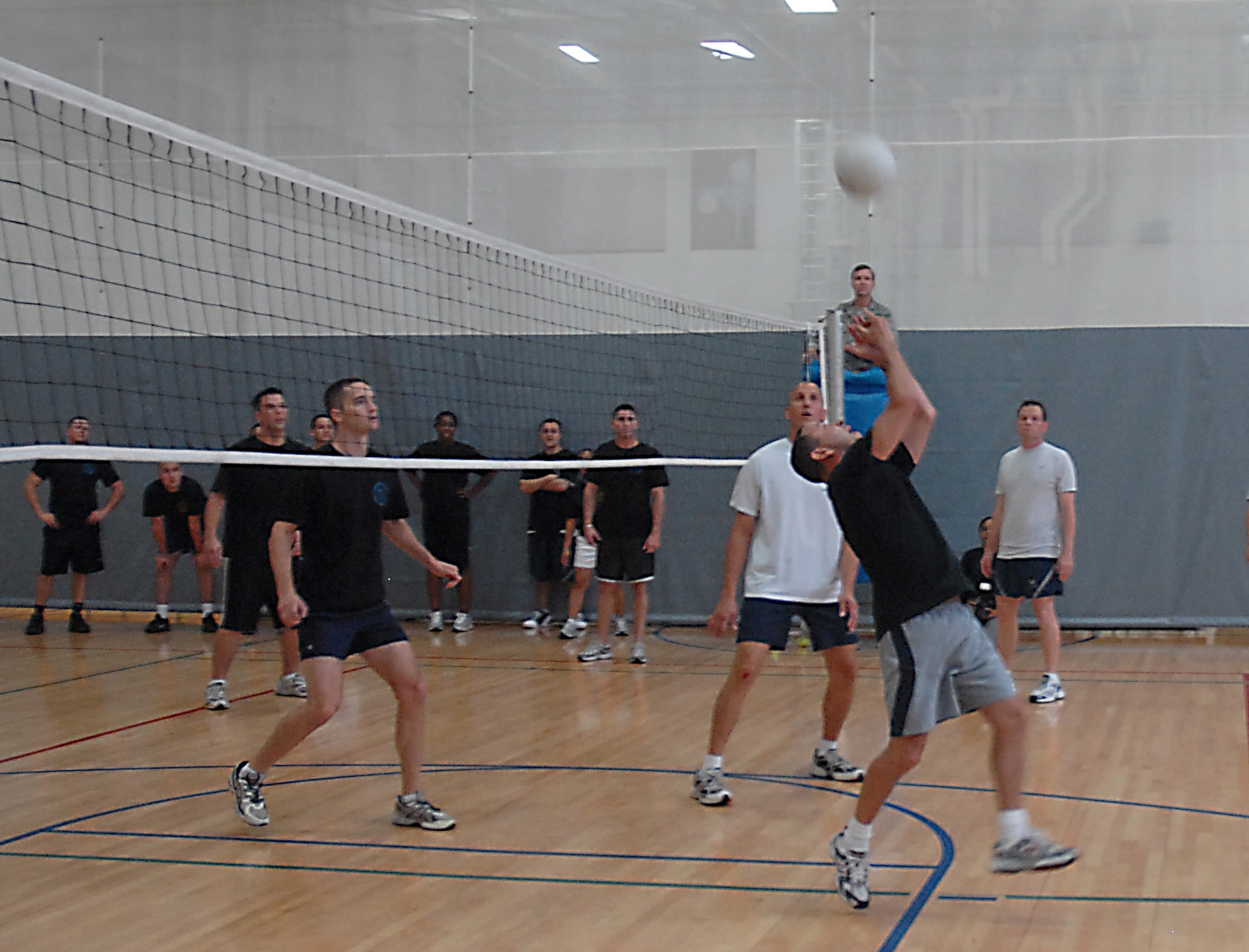 Patrick Dumka bumps the ball to the ALS team during a volleyball game on base Aug. 18. The Chiefs and Shirts team beat ALS 2-1. Dumka played for the Chiefs and Shirts from the 437th Maintenance Group.  (U.S. Air Force photo/Airman 1st Class Melissa White)