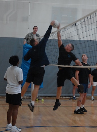 Rudy Tingelhoff hits the ball as Nathan Wallin attempts to block during a volleyball game on base Aug. 18. The Chiefs and Shirts team beat ALS 2-1. Tingelhoff played for the Chiefs and Shirts from the 437th Operations Group and Wallin is with ALS from the 128th Air Refueling Wing, Wisconsin Air National Guard.  (U.S. Air Force photo/Airman 1st Class Melissa White)