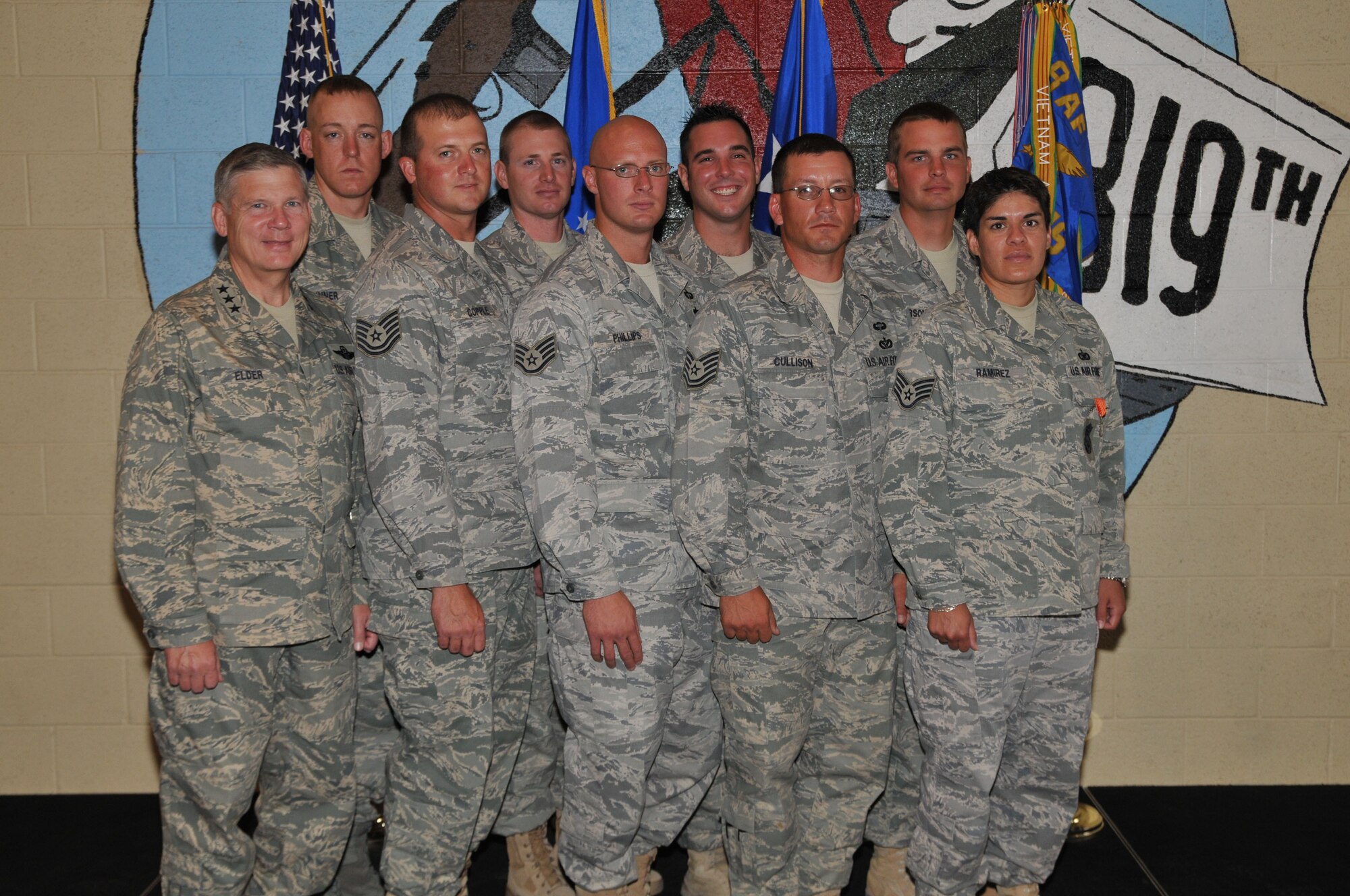 Lt. Gen. Robert Elder, Eighth Air Force (Air Forces Strategic) commander, poses with eight of the 11 members of the 819th RED HORSE Squadron who were presented Air Force Combat Action Medals Aug. 14 for their service while recently deployed to Iraq and Afghanistan. With the general are (left to right, front row to back row) Tech. Sgt. Bret Copple, Staff Sgt. Matthew Phillips, Tech. Sgt. Robert Cullison, Staff Sgt. Stephanie Rameriz, Staff Sgt. John Sinner, Staff Sgt. Douglas Ergish, Senior Airman Christopher D'Angelo and Staff Sgt. Casey Anderson. Not pictured are Tech. Sgt. Joseph Adair and Staff Sgts. Jason Bischoff and Douglas Ragone. (U.S. Air Force photo/John Turner)