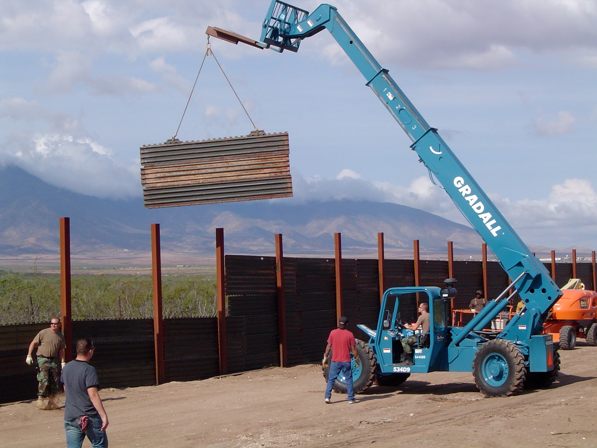 Airmen position the steel matting to extend fencing between the
United States and Mexico. (Photos courtesy 123rd Maintenance Squadron and
123rd Civil Engineering Squadron)