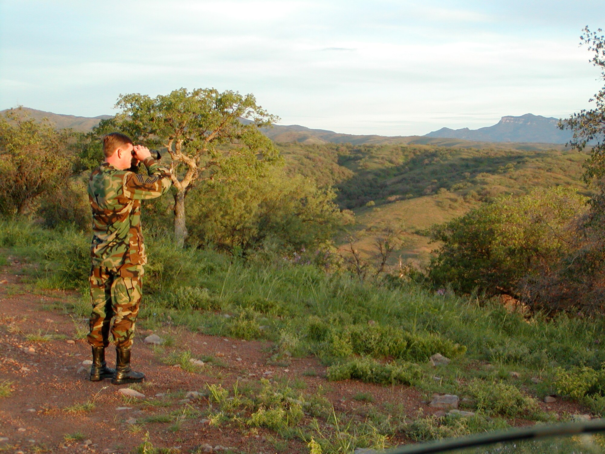 Chief Master Sgt. Roger Hamilton of the wing’s 123rd Maintenance Squadron scans
the Mariposa Wash for undocumented aliens west of Nogales, Ariz., in August. Chief
Hamilton is one of more than 100 Kentucky Air Guardsmen who have deployed this
year to enhance U.S. border security as part of Operation Jump Start.
(Photos courtesy 123rd Maintenance Squadron and 123rd Civil Engineering Squadron)