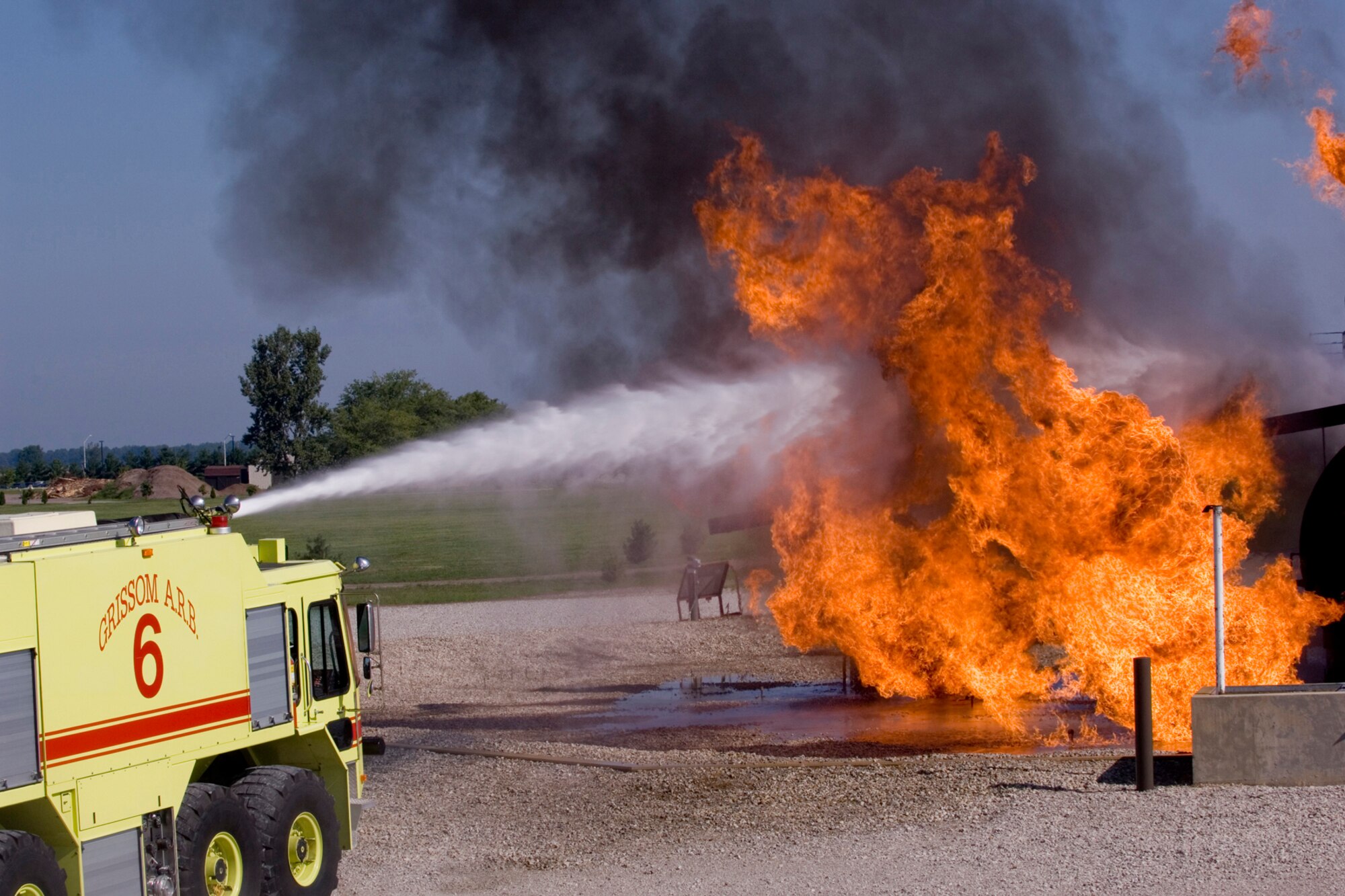 GRISSOM AIR RESERVE BASE, Ind., -- The Grissom Fire Department held hands-on demonstrations like this simulated aircraft fire as an educational tool for base employees.  Participants used the turret of the P-23 crash truck to battle a simulated aircraft fire at the fire training pit, and entered the 'smoke house' to see how fire fighters use a thermal imaging device to locate victims. (U.S. Air Force photo/Tech. Sgt. Doug Hays)