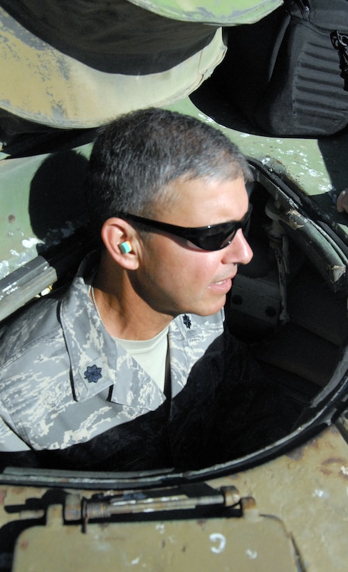 Lt. Col. Al Ozanian, 95th Medical Operations Squadron commander, drives an Army M60 tank Aug. 11 at the 412th Range Squadron precision impact range area. Colonel Ozanian was a former Army tank driver. (Air Force photo by Senior Airman Julius Delos Reyes)