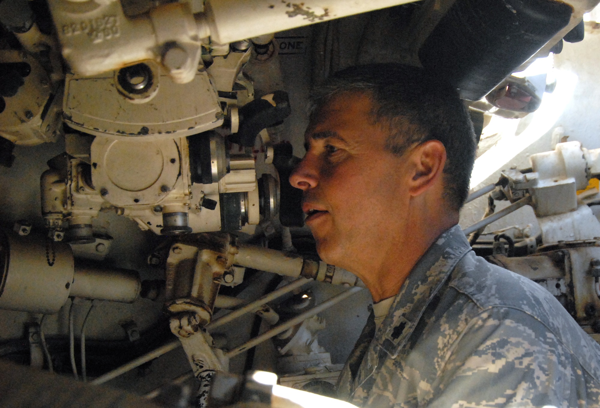 Lt. Col. Al Ozanian, 95th Medical Operations Squadron commander, checks some parts of an Army M60 tank. Colonel Ozanian received his Bachelor of Science in Psychology from Virginia State University in Petersburg, Va. He finished his Master of Science in Social Work from Virginia Commonwealth University in Richmond, Va., and then commissioned with the Air Force. (Air Force photo by Senior Airman Julius Delos Reyes)