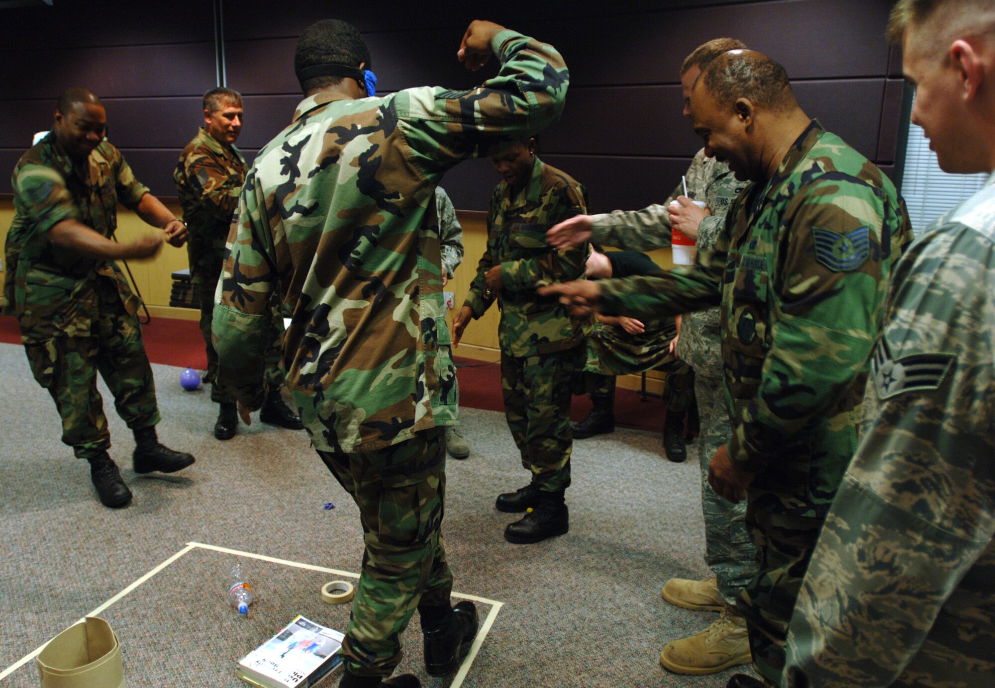 Staff Sgt. Micheal Sloan's team members watch him make his way through a simulated mine field while blindfolded. The exercise was part of a two-week Noncommissioned Officer Leadership Development Program course that Sergeant Sloan and 20 other Airmen from the 931st Air Refueling Group graduated on Aug. 15.  Sergeant Sloan is assigned to the 931st Civil Engineer Squadron. (U.S. Air Force photo/Tech. Sgt. Jason Schaap)