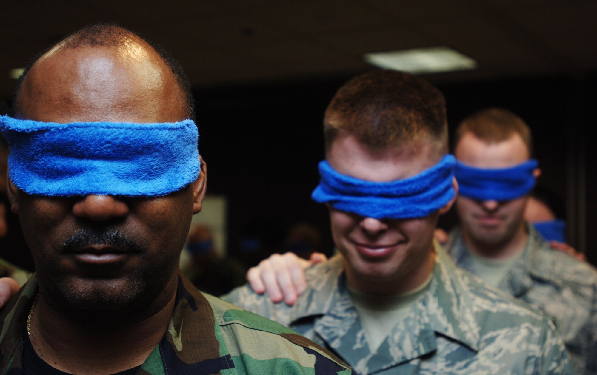 Tech. Sgt. Milton Willhight(far left), Senior Airman Nathen Hornecker (middle) and Staff Sgt. Keith Yoho wait to be led through a team-building exercise built into a two-week Noncommissioned Officer Leadership Development Program course that concluded on Aug. 15. The three Airmen were blindfolded to simulate vision loss from exposure to a poisonous gas. Sergeant Willhight and Airman Hornecker are assigned to the 931st Aircraft Maintenance Squadron. Sergeant Yoho is assigned to the 931st Aerospace Medicine Flight. (U.S. Air Force photo/Tech. Sgt. Jason Schaap)