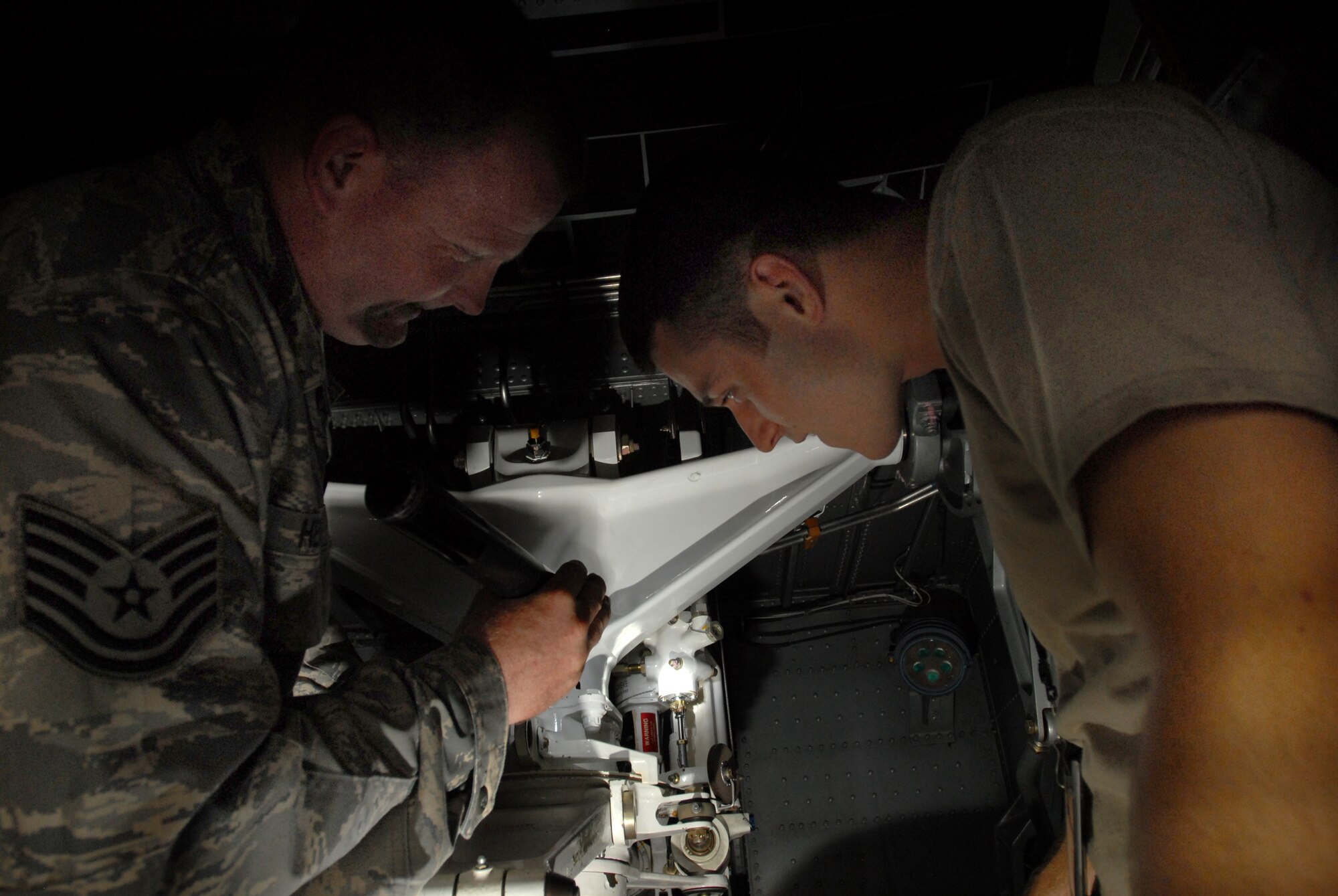 LITTLE ROCK AIR FORCE BASE, Ark.--Tech. Sgt Jason Hensel, 314th Maintenance Group instructs Senior Airman Derek Webb, 314th Maintenance Squadron, about breaks on the C-130 on the flightline on July 29, 2008.  (U.S. Air Force photo by Senior Airman Christine Clark)(Released)