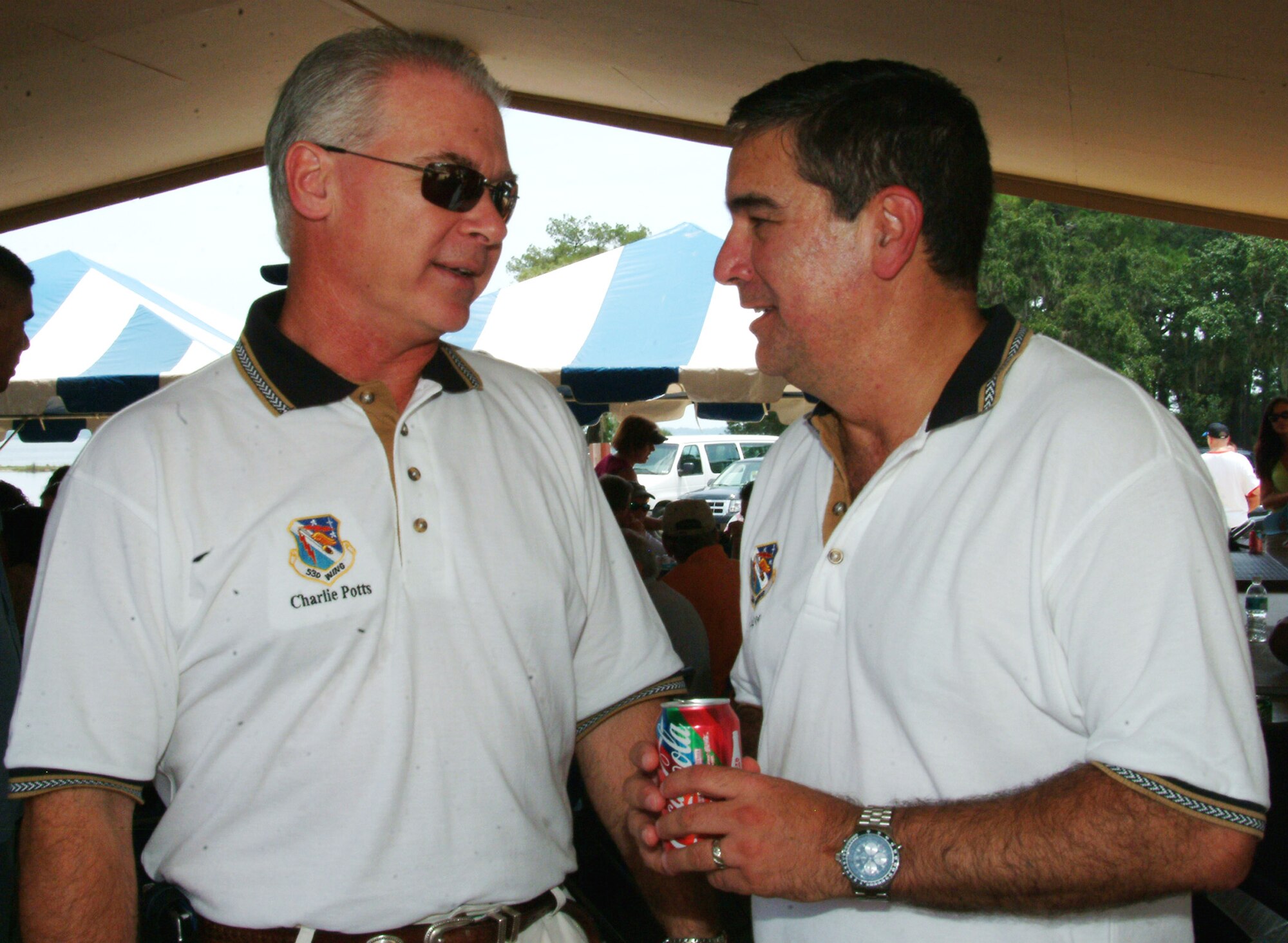 Charlie Potts, 86th Fighter Weapons Squadron Honorary Commander, talks with Col. Mick Guthals, 53d Wing Vice Commander during the Aug. 14 53d Wing Picnic at Post’l Point, Eglin Air Force Base, Fla.  Wing members participated in numerous sporting events throughout the day culminating in a wing cookout. Photo by Capt. Carrie L. Kessler.