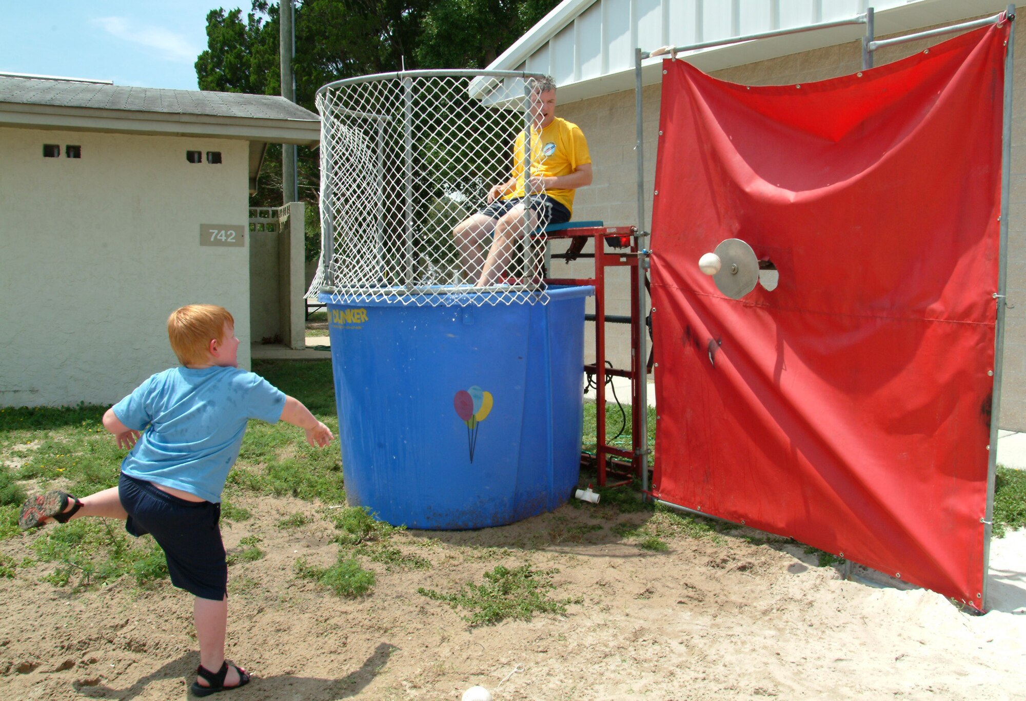 Maj. Tim Welde, 16th Electronic Warfare Squadron, prepares to take the plunge in the dunking booth during the Aug. 14 53d Wing Picnic at Post’l Point, Eglin Air Force Base, Fla.  Wing members participated in numerous sporting events throughout the day culminating in a wing cookout.  Photo by Capt. Carrie L. Kessler.