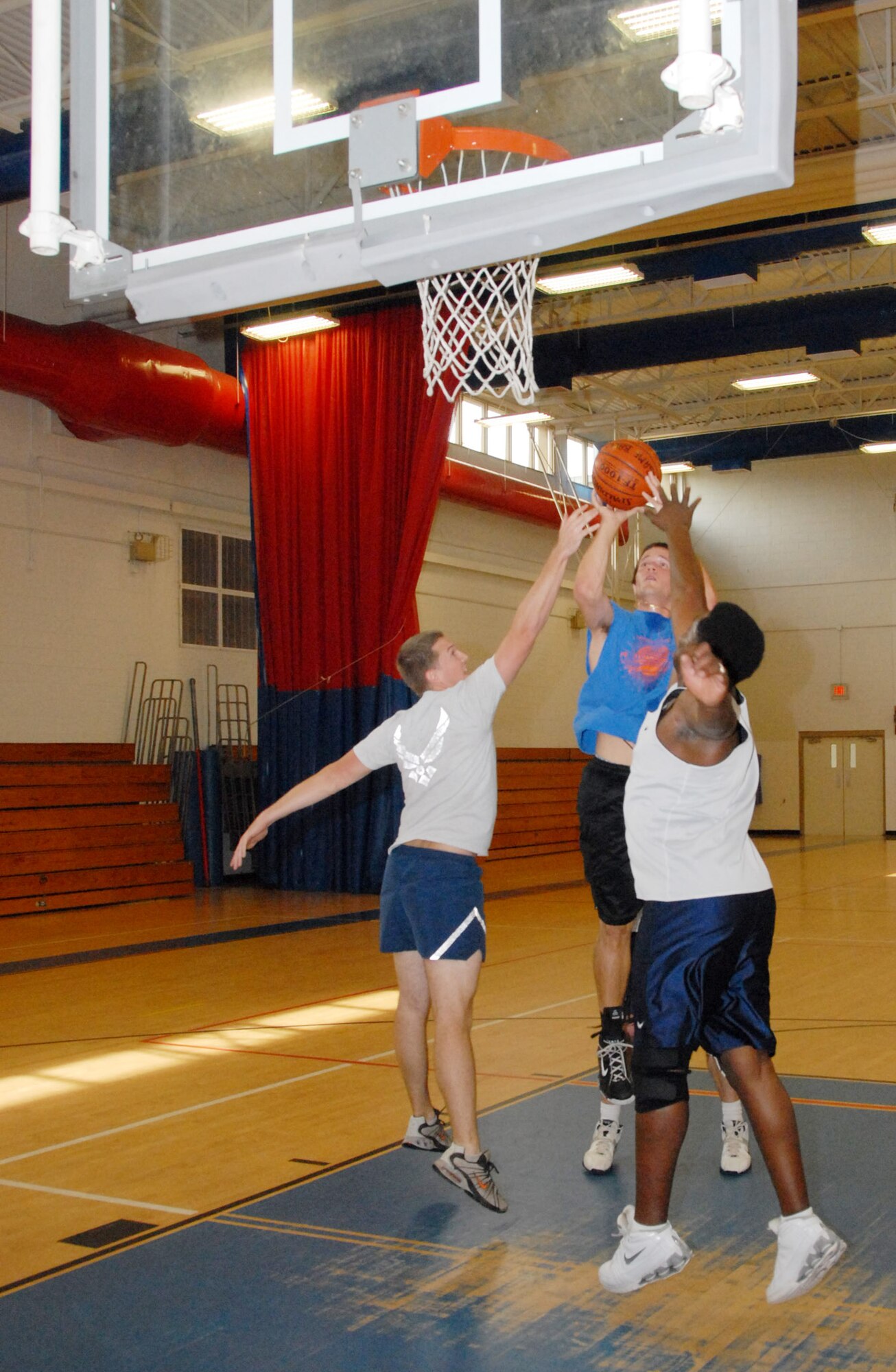 Bradley Clinger, 28th Test and Evaluation Squadron, goes up for a jump shot over two defenders in a game during the basketball tournament – part of the 53d Wing’s picnic activities.  The 16th Electronic Warfare Squadron also won the basketball tournament.  Photo by Staff Sgt. Samuel King Jr.