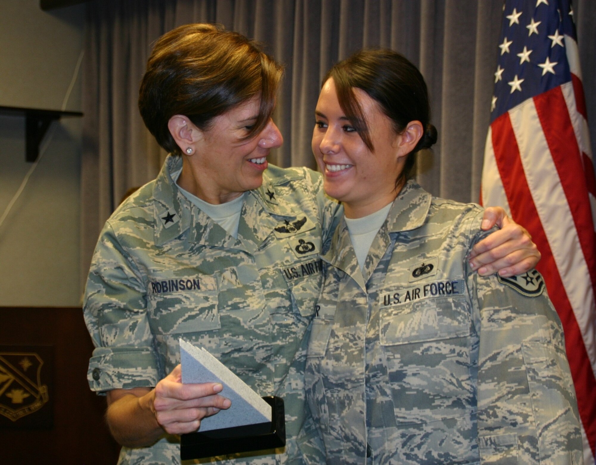 General Robinson presents a quarterly award to Staff Sgt. Kalonna Miller. 