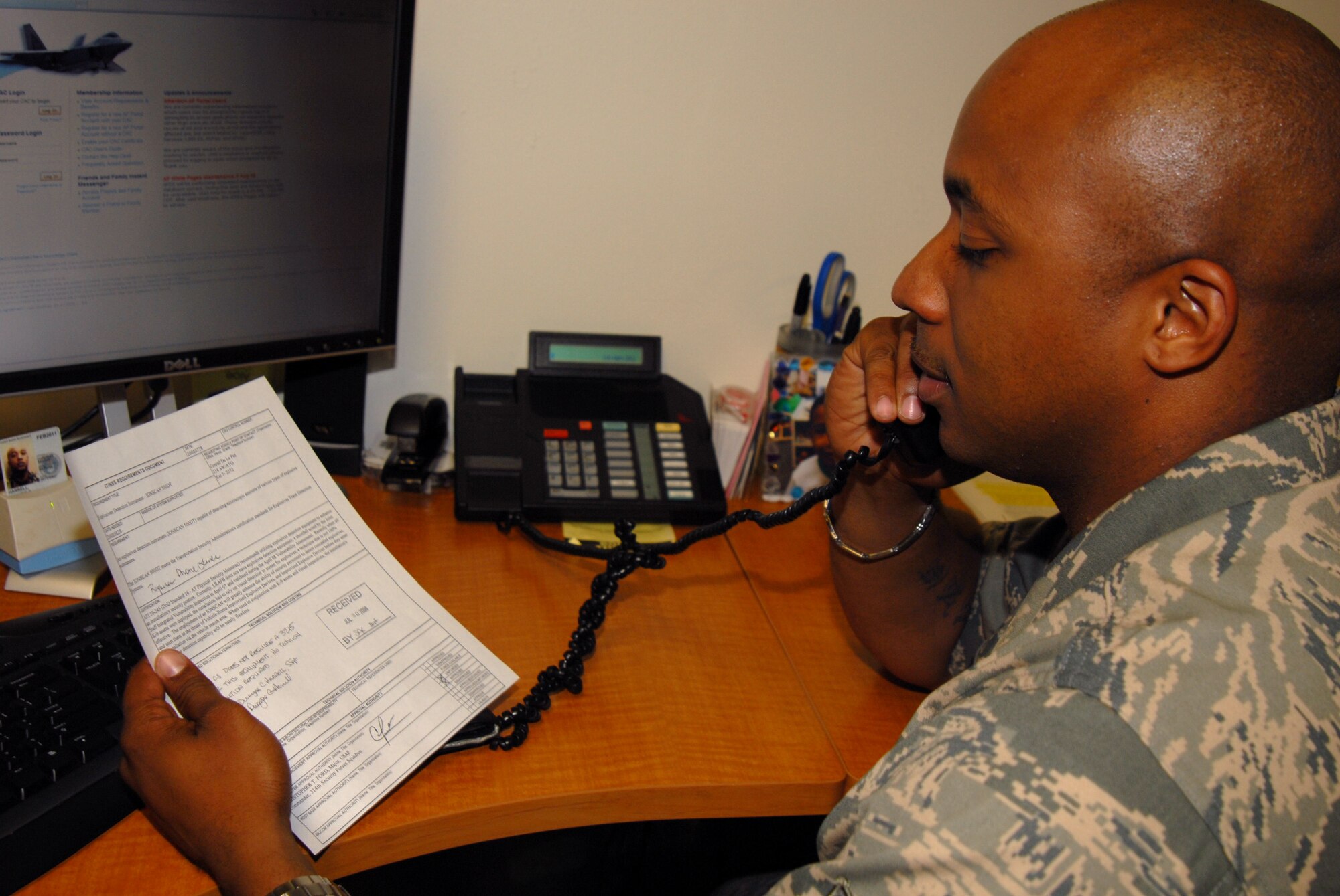 Staff Sgt. Dwayne Harrell, 314thCommunication Squadron project manager, discusses a requirement form with a customer. (U.S. Air Force photo by Airman 1st Class Vanessa Dale)
