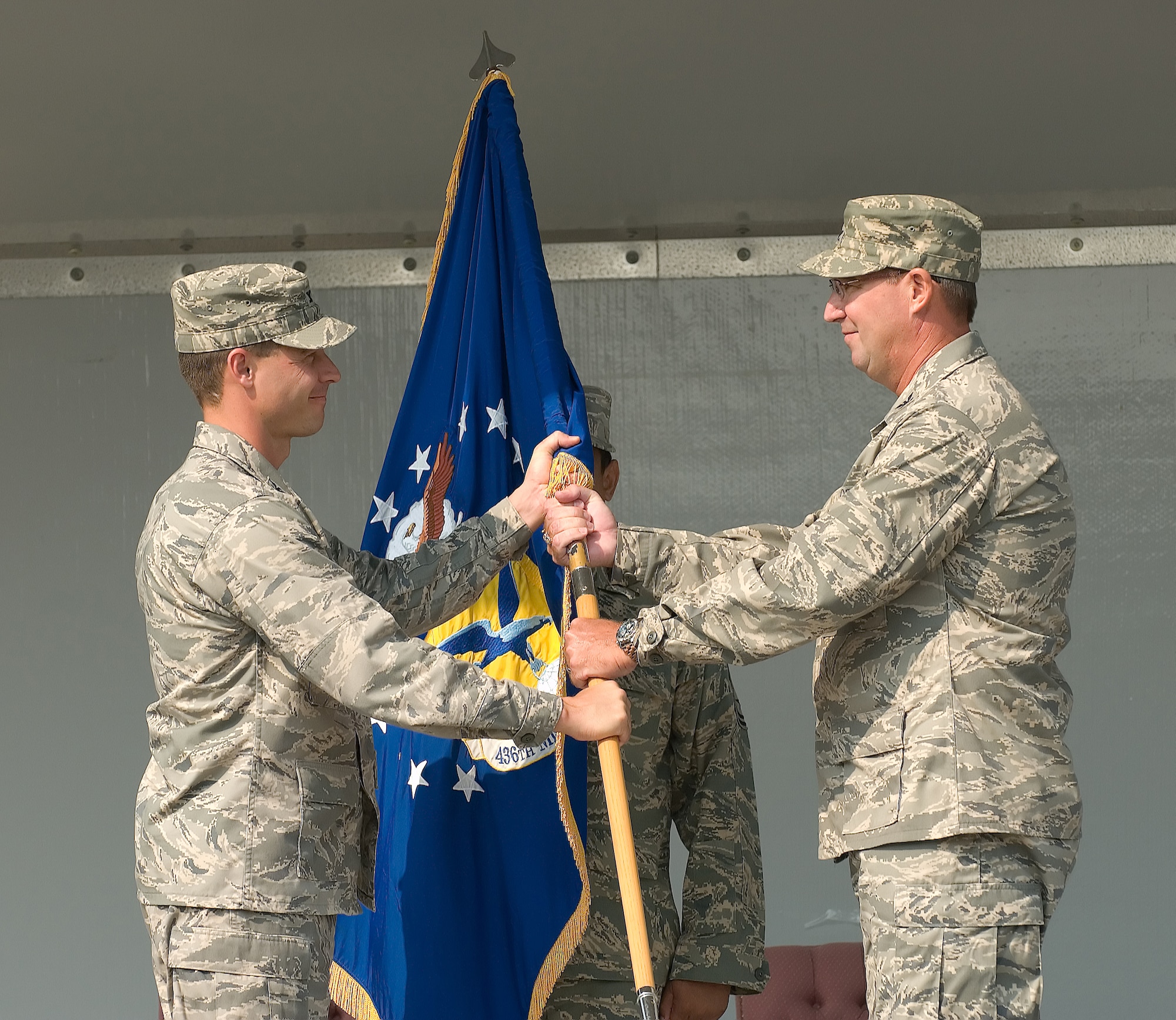 DOVER AIR FORCE BASE, Del. – Col. Todd Emmert (right), 436th Mission Support Group commander, accepts the 436th MSG guidon and command of the 436th MSG from Col. Steve Harrison, 436th Airlift Wing commander, during a change of command ceremony Aug. 15 at the Air Mobility Command Museum. Col. Todd Emmert, 436th MSG commander, assumed command from Col. Vic Sowers, who is headed to the Pentagon. (U.S. Air Force photo/Jason Minto)