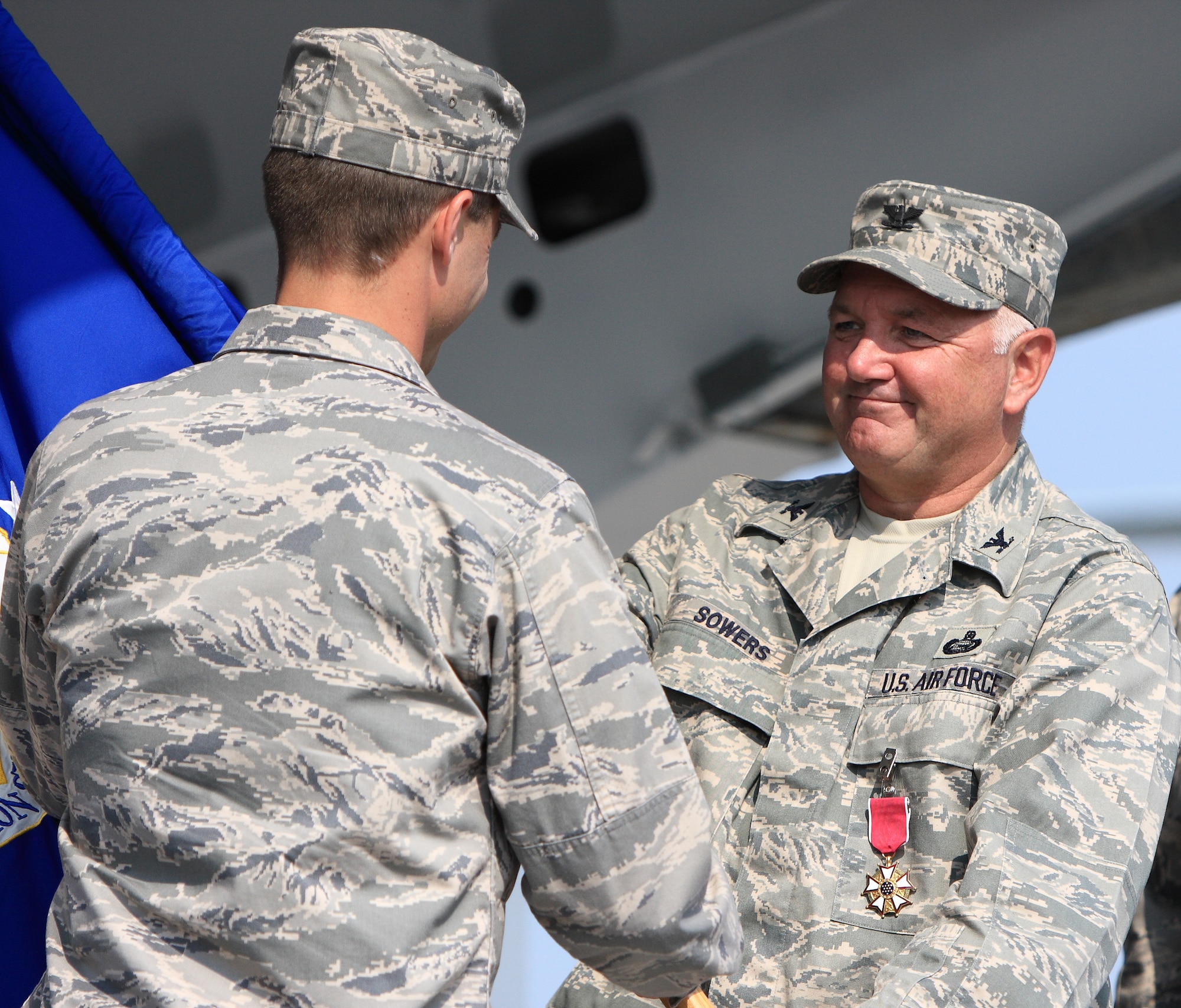 DOVER AIR FORCE BASE, Del. – Col. Vic Sowers (right), hands the 436th Mission Support Group guidon to Col. Steve, Harrison, 436th Airlift Wing commander, during the 436th MSG change of command ceremony Aug. 15 at the Air Mobility Command Museum. Col. Todd Emmert, 436th MSG commander, assumed command from Col. Vic Sowers, who is headed to the Pentagon. (U.S. Air Force photo/Roland Balik)