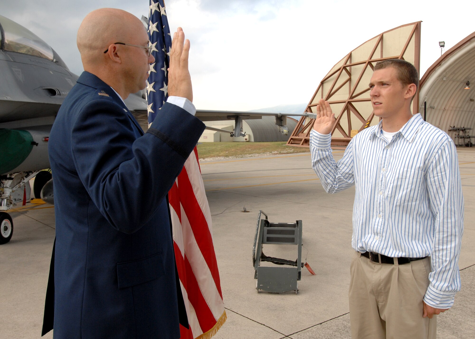 AVIANO AIR BASE, Italy --  Capt. Charles Hudson of the 603rd Air Control Squadron administers the oath of enlistment to his son, Marcus Hudson, Aug.12 on the base flightline.  (U.S. Air Force photo/Airman 1st Class Tabitha M. Mans)