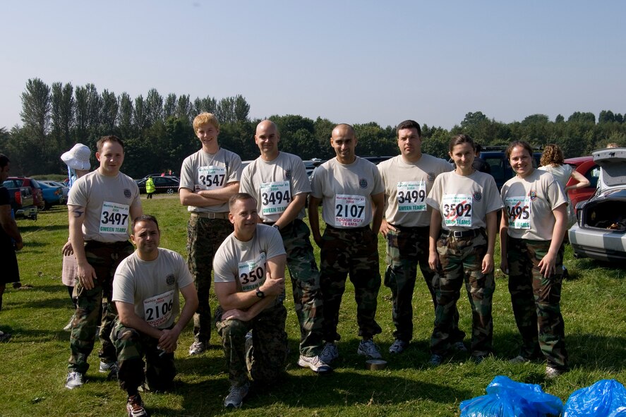 The JAC-HAMMERS Team for the Tough Guy Nettle Warrior 2008 Competition:  (L-R) Kneeling:  Navy Lt. Jose Lepesuastegui, Marine Corps Col. Pete Devlin; Standing Navy Petty Oficer Third Class Joseph Libbard. Anthony Devlin, Navy Lieutenant Commander J. Wayne Hill, Lt. John Rahaghi, Chief Petty Officer Nick Williams, Ms. Ivana Young and Navy Lt. Katie Hall.  (U.S. Air Force Photo by Staff Sgt. Chad E. Chisholm)