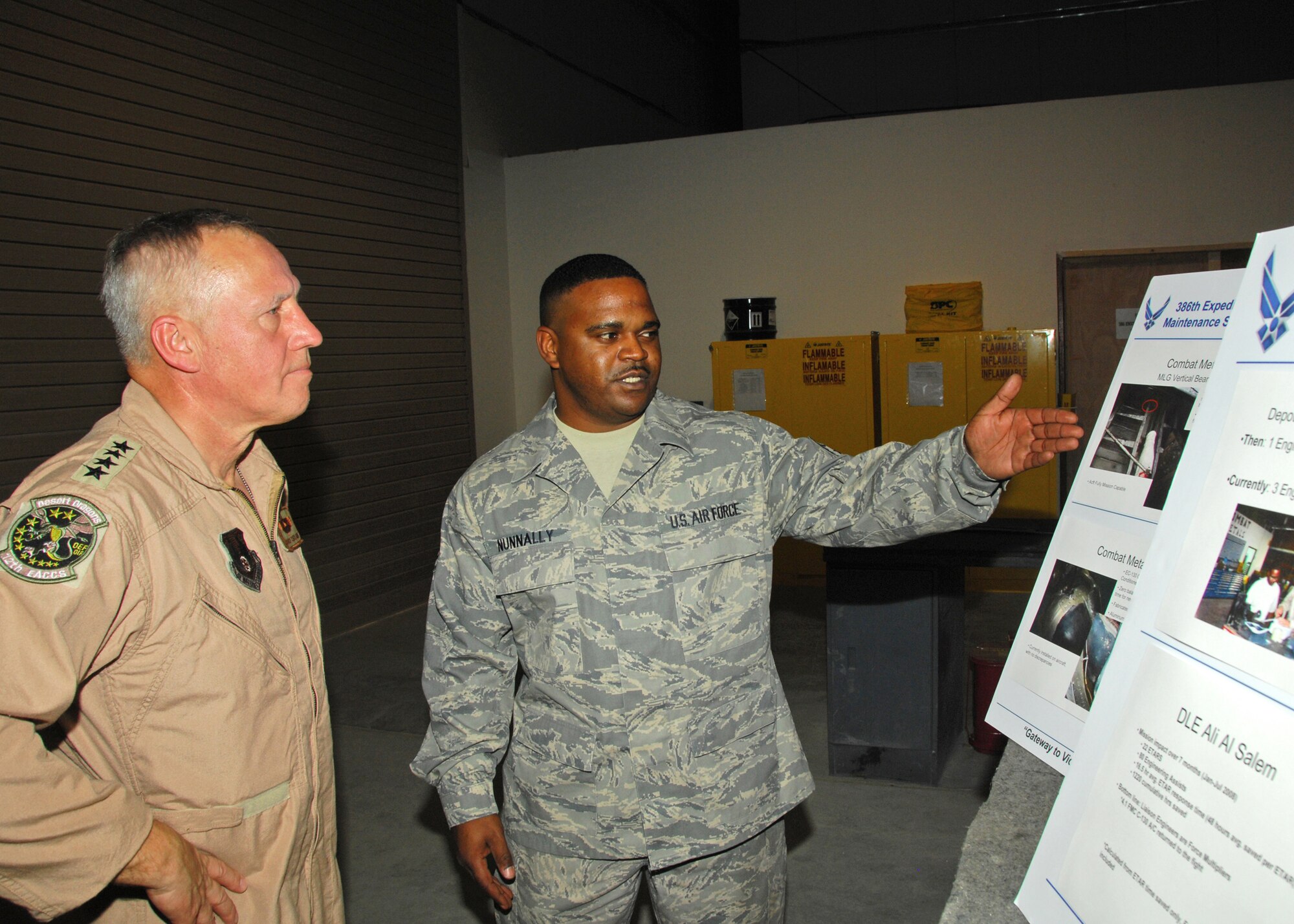 SOUTHWEST ASIA -- Gen. Bruce Carlson, commander of Air Force Materiel Command, listens to a briefing from Staff Sgt. Shareef Nunnally, Structural Maintenance NCO in charge, on Aug. 18 about the Combat Metals shop's fabrication and repair efforts to keep C-130s flying at an air base in Southwest Asia. General Carlson met with members of the 386th Air Expeditionary Wing to see how AFMC can assist with current operations in the U.S. Central Command area of responsibility. (U.S. Air Force photo/Tech. Sgt. Raheem Moore)