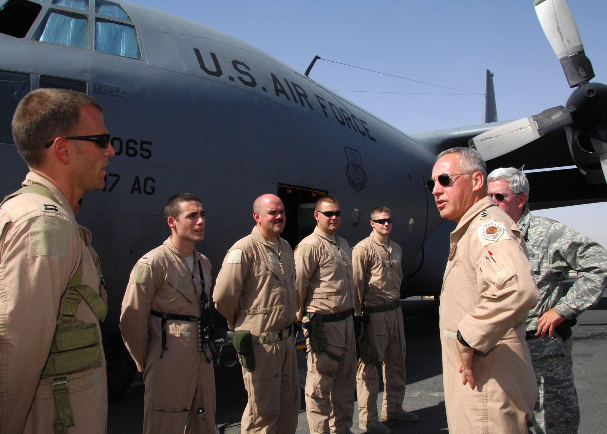 SOUTHWEST ASIA -- Gen. Bruce Carlson, commander of Air Force Materiel Command, visits with a C-130 crew prior to a mission to Iraq on Aug. 18 at an air base in Southwest Asia. General Carlson met with members of the 386th Air Expeditionary Wing to see how AFMC can assist with current operations in the U.S. Central Command area of responsibility. (U.S. Air Force photo/Tech. Sgt. Raheem Moore)