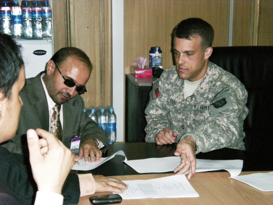 Abdul Qadeer Fitrat, the Central Bank of Afghanistan’s governor, and Army Maj. Noah Cloud, 101st Joint Logistics Command finance officer, meet at Camp Eggers, Afghanistan, Aug. 7, 2008, to sign a memorandum that changes the banking relationship between U.S. forces and the Central Bank of Afghanistan. U.S. Army photo by 1st Lt. Meagan Newsom