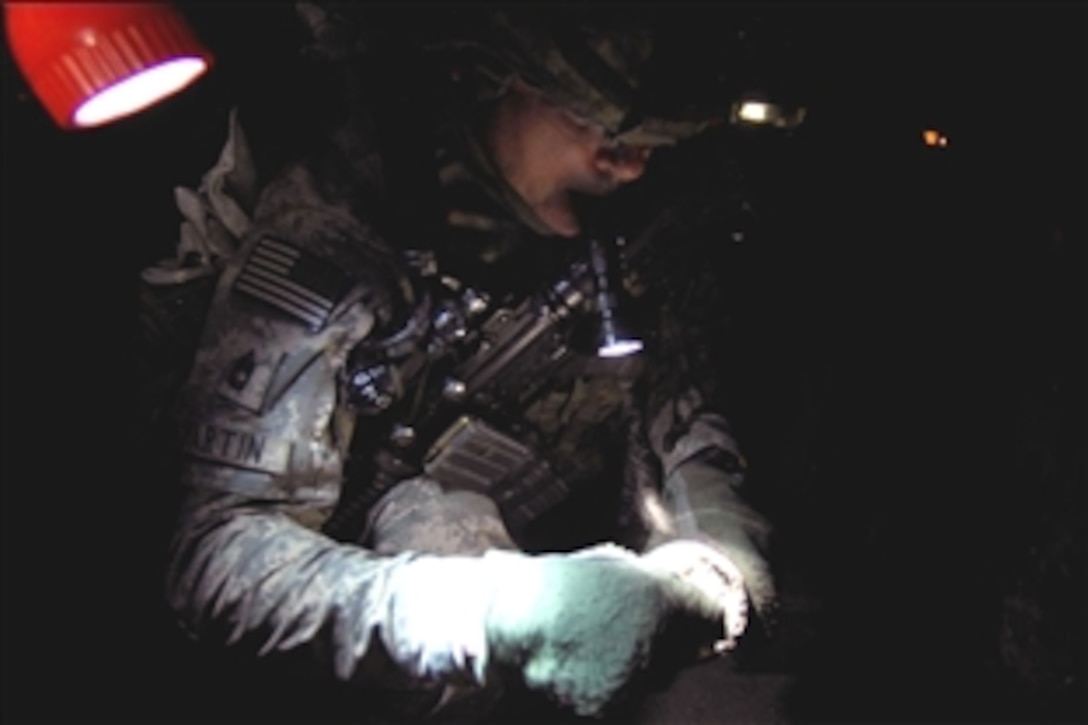 U.S. Army Sgt. 1st Class Jeffery Martin inspects bomb-making material after a Sons of Iraq citizen patrol searched a house in Baghdad, Iraq, Aug. 13, 2008. Martin is assigned to the 10th Mountain Division's 2nd Infantry Regiment, 4th Brigade Combat Team. 
