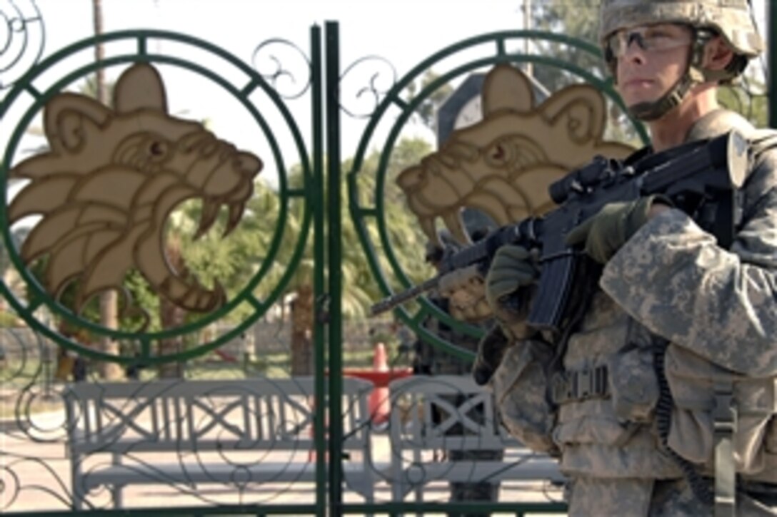 A U.S. Army soldier provides security at the debut of two new tigers at the Baghdad Zoo in Baghdad, Iraq, Aug. 8, 2008. The soldier is assigned to the 4th Infantry Division's Battery A, 4th Battalion, 42nd Field Artillery.