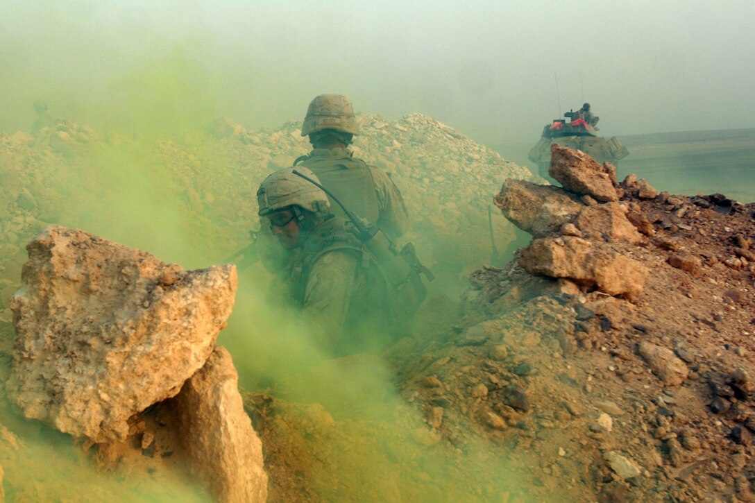 Al QATRANAH, Jordan, (Aug. 19, 2008) -- Sgt. Alexander Hebert, a Scout Section Leader with the Light Armored Vehicle platoon, 15th Marine Expeditionary Unit, provides cover as a smoke grenade masks the teams retrograde to a LAV in Jordanian desert during "Operation Infinite Moonlight." For the LAV platoon the purpose of the training was to refine basic infantry tactics such as trench assaults, weaponry skills, ambush training and a gunnery skills with the LAV's main cannon.  The Camp Pendleton, Calif., based  15th MEU  is comprised of approximately 2,200 Marines and Sailors and is a forward deployed force in readiness capable of conducting numerous operations, such as Non-Combatant Evacuation Operations, Humanitarian Assistance Operations and range of  amphibious missions. The MEU is currently deployed aboard USS Peleliu (LHA-5), USS Dubuque (LPD-8) and USS Pearl Harbor (LSD-52). (Official USMC photo by Cpl. Stephen Holt)(Released)::r::::n::