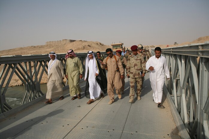 Iraqi Army Soldiers with the 2nd Battalion, 2nd Quick Reaction Force, 1st Iraqi Division, escort local Sheiks and tribal leaders across a newly constructed bridge Aug. 19.  The new Salem Bridge was built in the Bagharra region of Iraq and provides passage over the Thar Thar Canal. Insurgents destroyed the original bridge over a year ago.