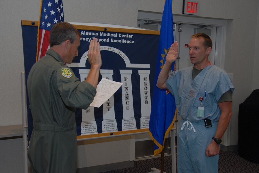 Col. Robert Becklund, 119th Wing Commander, swears in Dr. (Maj.) Craig Smith into the N.D. Air National Guard on Aug. 20, 2008 at St. Alexius Medical Center. Smith will serve as a flight surgeon for the 119th Wing. 
