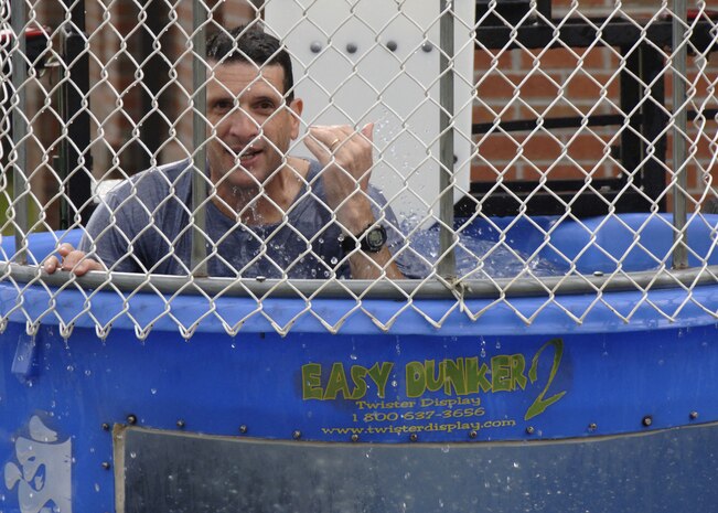 Col. Joseph Mancy surfaces after getting dunked by guests at the operational readiness inspection celebration picnic Aug. 15 at the Charleston Club. The Air Mobility Command Inspector General?s Office recognized more than 32 Airmen and Department of Defense civilians for their efforts during the ORI and more than 15 special teams for outstanding performance during the inspection. Colonel Mancy is the 437th Operations Group commander. (U.S. Air Force photo/Airman 1st Class Timothy Taylor)