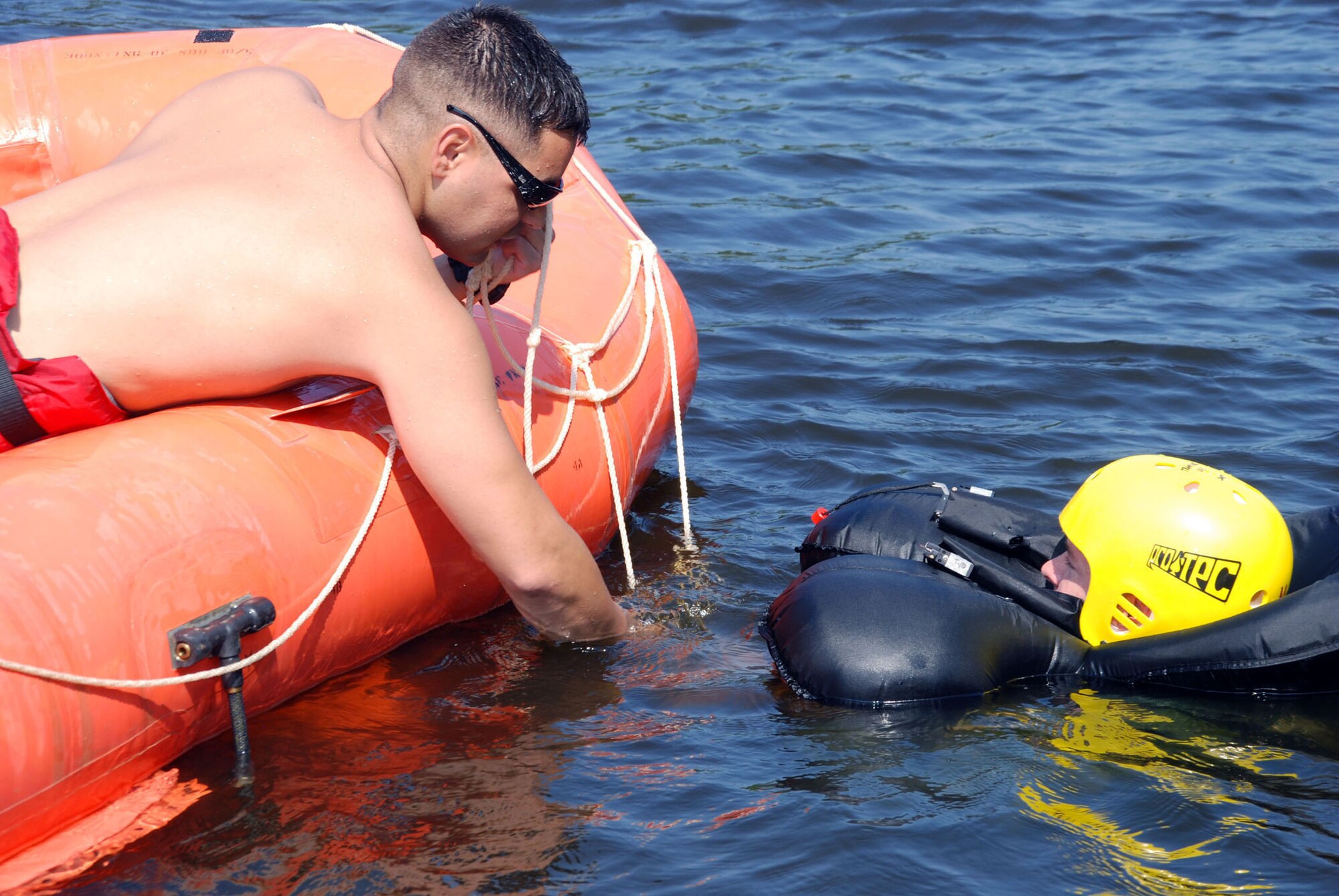 93rd Bomb Squadron Aircrew Flight Equipment technician, Staff Sgt. Curtis Downey, shows Lt. Col. Scott Forrest, a 93 BS, B-52 aircrew member, the ladder used to climb into the nine-man life raft during water survival training at Black Bayou REservoir, Louisiana. (U.S. Air Force photo by Tech. Sgt. Andre Menard) (Released)