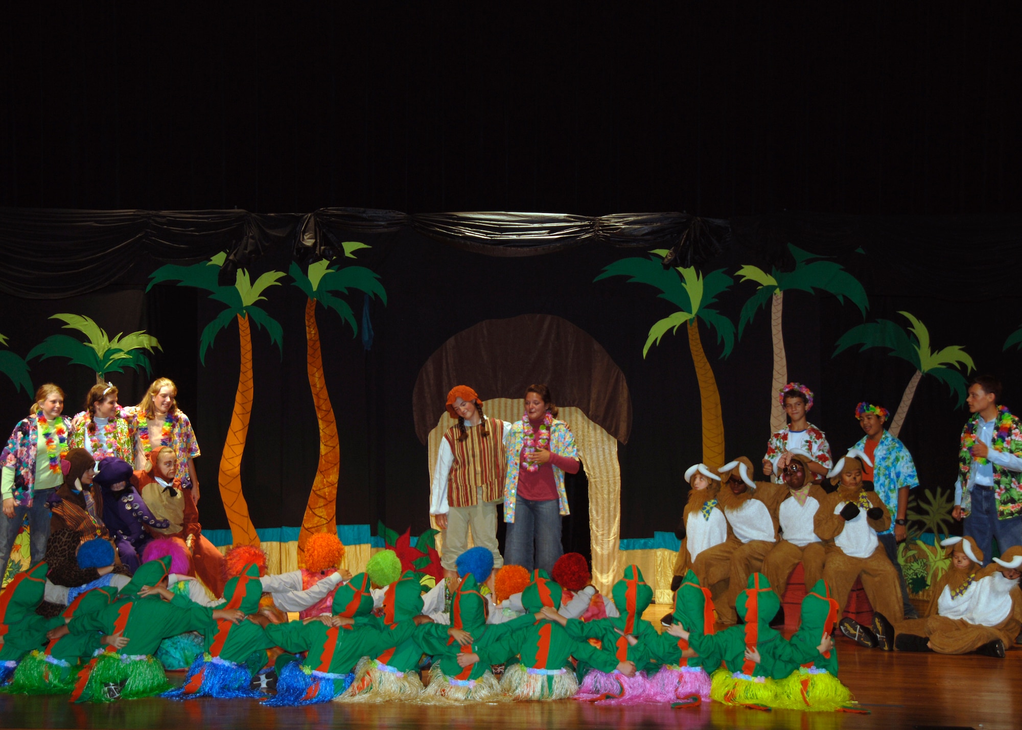 The cast joins together in song at the end of a play held at the base theater Aug. 16. Dozens of family members watched as their sons and daughters performed a remake of ?The Amazing Adventures of Robinson Crusoe? play brought to Charleston AFB by the Missoula Children?s Theatre. (U.S. Air Force photo/Airman 1st Class Timothy Taylor)