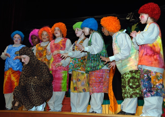 Megan Reash gets frightened by the ?Frowny Face Tribe? during ?The Amazing Adventures of Robinson Crusoe? play at the base theater Aug. 16. Megan, 14, is the daughter of Tech. Sgt. Gary Reash and his wife Sara. (U.S. Air Force photo/Airman 1st Class Timothy Taylor)