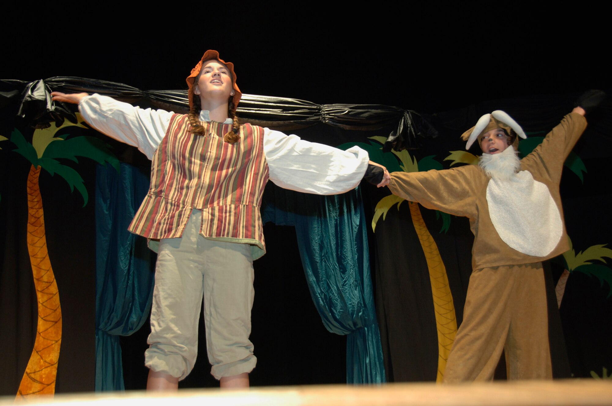 Jordan Stauffer and Edward Ceber sing a duet together during ?The Amazing Adventures of Robinson Crusoe? play at the base theater Aug. 16. Jordan, 16, is the daughter of Maj. Curtis Stauffer and his wife Jennifer. (U.S. Air Force photo/Airman 1st Class Timothy Taylor)