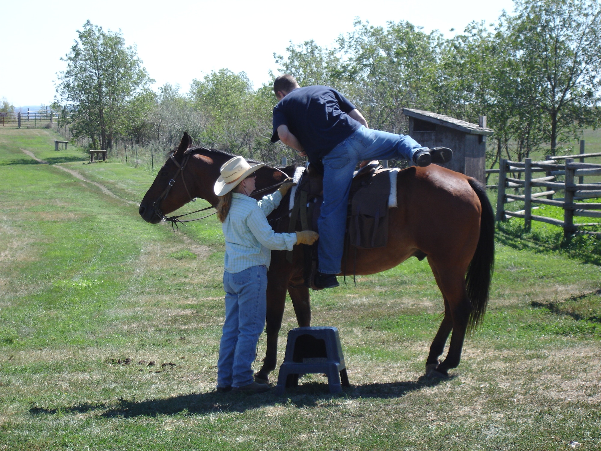 KILLDEER, N.D. -- 1st. Lt. Dustin Faircloth, 23rd Bomb Squadron, mounts a horse named Pumpkin to go on a Badlands trail ride here Aug. 16. The horseback ride was part of a summer trip sponsored by 5th Force Support Squadron Outdoor Recreation at Minot Air Force Base. Lieutenant Faircloth was one of almost 20 men, women and children from base who participated in the three-hour ride. For information on upcoming Outdoor Recreation trips and activities, contact 723-3648.(U.S. Air Force photo by Maj. Elizabeth Ortiz)