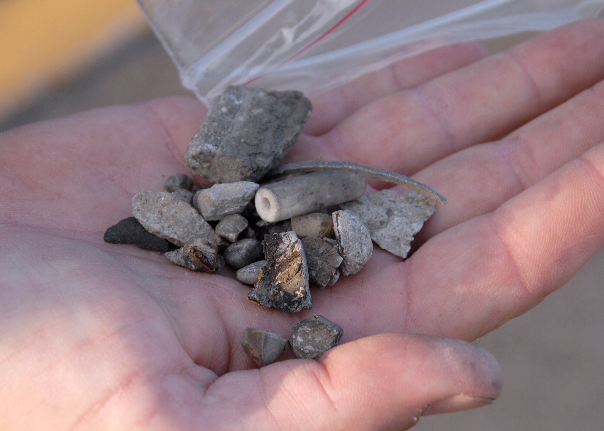 Foreign object debris (FOD) is collected at the flight line located on Wright-Patterson Air Force Base, Ohio, on August 20, 2008. FOD walks are a good way of housekeeping around the aircraft, and policing the flightline area in search of possible foreign objects that could be ingested into engines potentially causing damage. (U.S. Air Force photo by Senior Airman Ken LaRock)                      