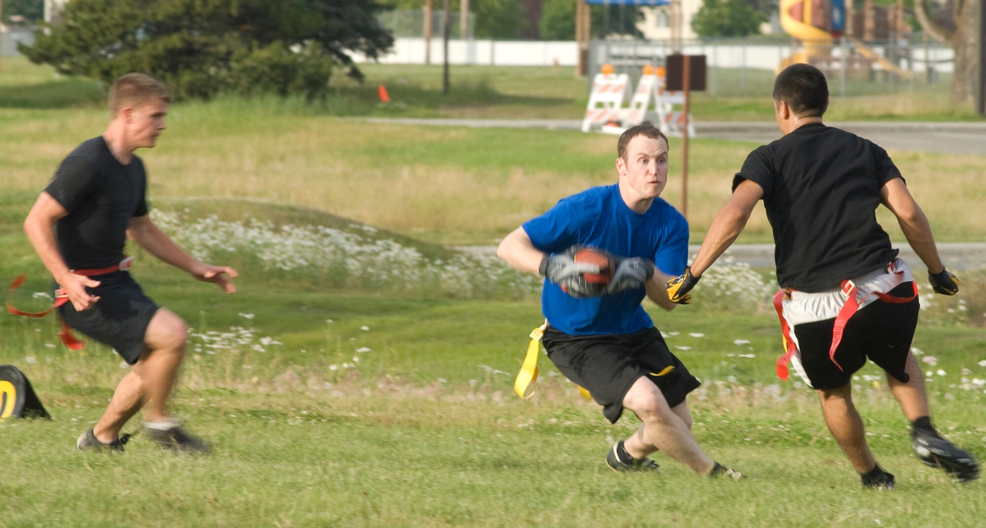 ELMENDORF AIR FORCE BASE, Alaska -- Aaron Conine, a member of the 3rd Civil Engineer Squadron flag football team, tries to makes a move on Zac Gowin during the flag football game Aug. 19. After getting behind early, the 3rd CES team scored 19 unanswered points winning their third game of the season. (U.S. Air Force photo)