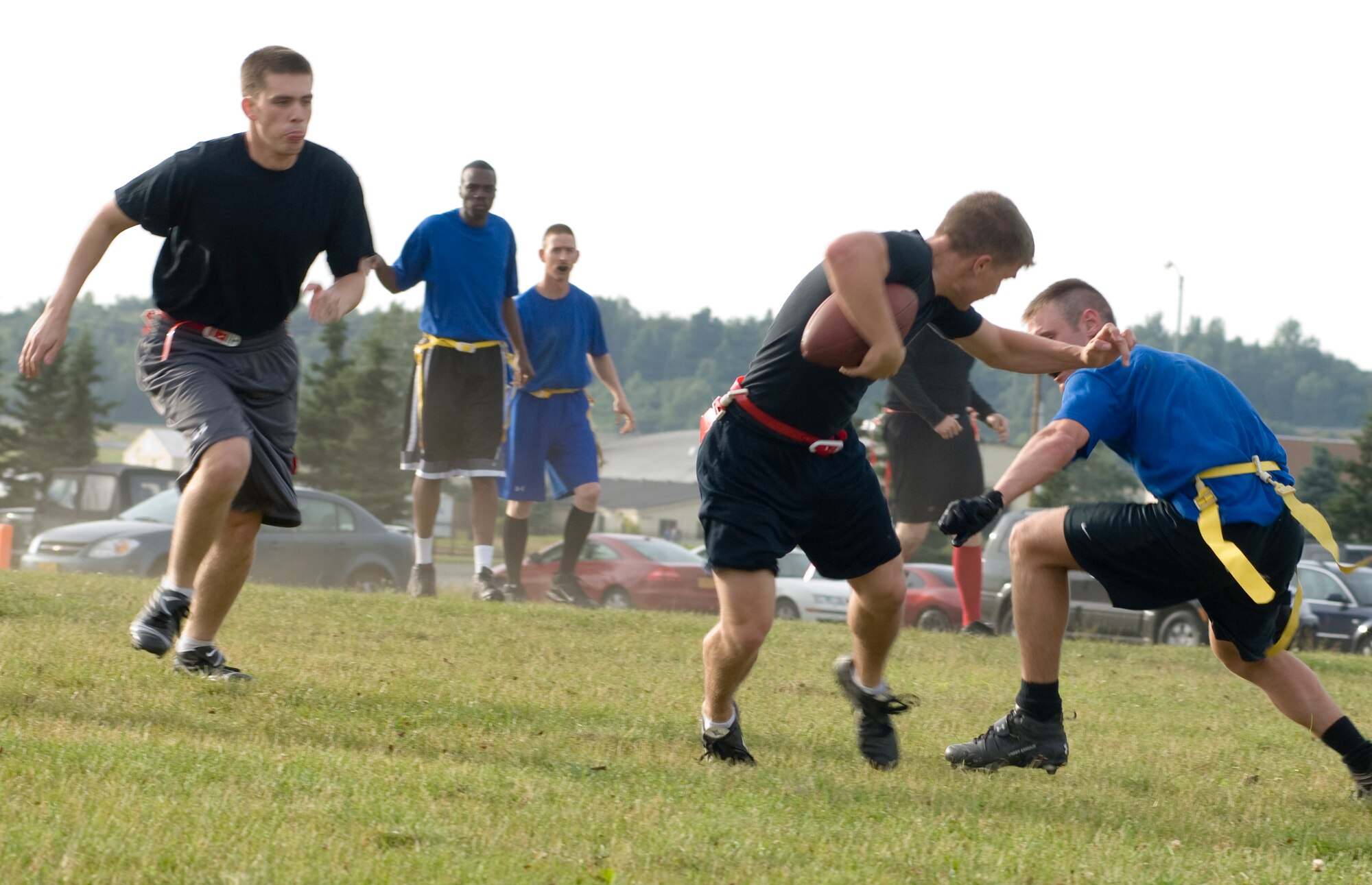 ELMENDORF AIR FORCE BASE, Alaska -- Eric Nevins, a member of the 381st Intelligence Squadron flag football team, tries to escape from Nicholas Porter. Scoring the first touchdown of the contest, the team fell short, 19-7. (U.S. Air Force photo)