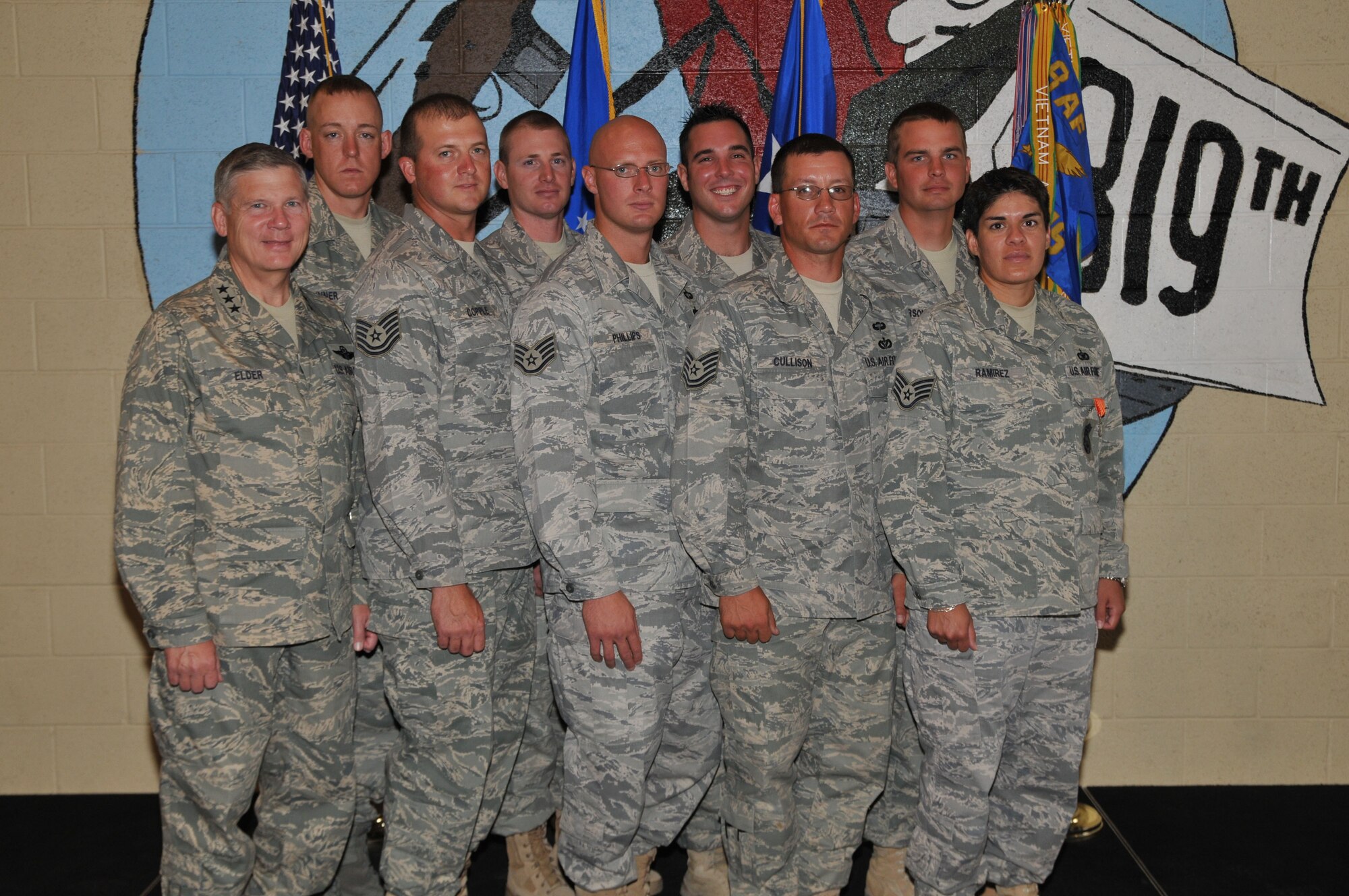 Lt. Gen. Robert Elder, 8th Air Force commander, poses with eight of the 11 members of the 819th RED HORSE Squadron who were presented Air Force Combat Action Medals Aug. 14 for their service while recently deployed to Iraq and Afghanistan. With the general are (left to right, front row to back row) Tech. Sgt. Bret Copple, Staff Sgt. Matthew Phillips, Tech. Sgt. Robert Cullison, Staff Sgt. Stephanie Rameriz, Staff Sgt. John Sinner, Staff Sgt. Douglas Ergish, Senior Airman Christopher D'Angelo and Staff Sgt. Casey Anderson. Not pictured are Tech. Sgt. Joseph Adair and Staff Sgts. Jason Bischoff and Douglas Ragone. (U.S. Air Force photo/John Turner)